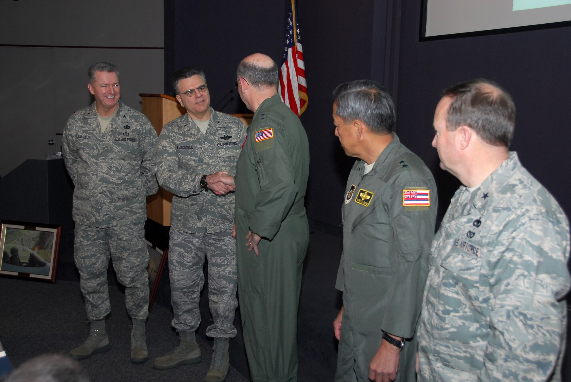During the recent Air National Guard Strategic Planning System Steering Committee meeting held at the Air Force Conference Center, Andrews AFB, MD, Maj Gen Buddy Titshaw, Acting Director Air National Guard, welcomes the incoming steering committee leadership team of Brig Gen Gary Magonigle, SPS Executive Chairman, and Brig Gen Joe Balskus, SPS Executive Vice Chairman.  Looking on are the outgoing steering committee leadership team of Maj Gen Daryl Wong and Brig Gen Don Haught.