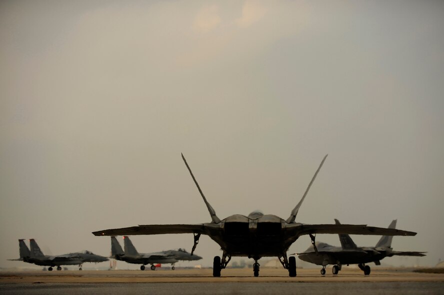 Two U.S. Air Force F-22A Raptors taxi down the ramp for a local mission Jan. 20 at Kadena Air Base, Japan. The F-22A is deployed from the 27th Fighter Squadron at Langley Air Force Base, Va. (U.S. Air Force photo/Master Sgt. Andy Dunaway) 