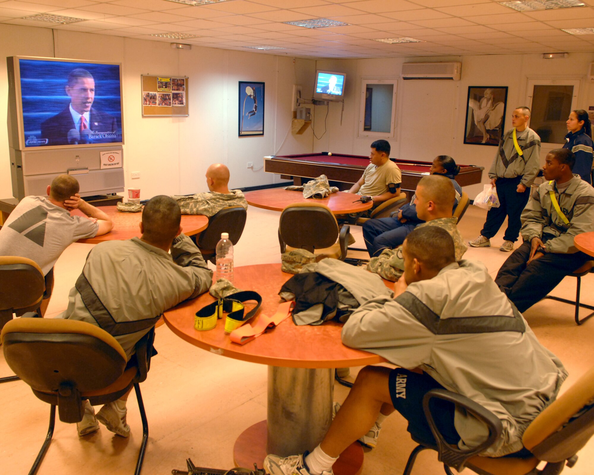 KIRKUK REGIONAL AIR BASE, Iraq – Deployed Airmen and Soldiers gathered in an on-base recreation center here to watch newly elected President Barack Obama speak Jan. 20 after taking oath during his official presidential inauguration in Washington. Service members also watched their commander in chief on televisions in dining facilities, fitness centers, offices, and rooms  (U.S. Air Force photo/Senior Airman Jessica Lockoski)