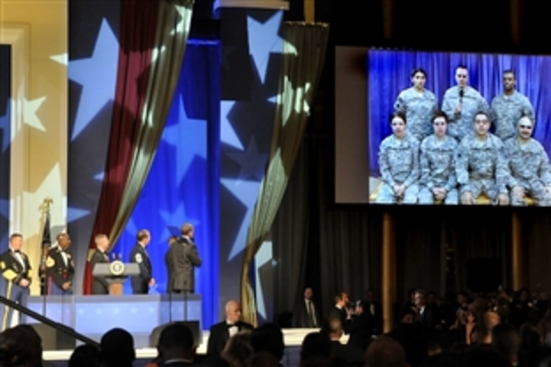 President Barack Obama speaks to deployed U.S. service members via satellite during the Commander in Chief's Ball in downtown Washington, D.C., Jan. 20, 2009.  Three hundred wounded warriors from Walter Reed Army Medical Center in Washington, D.C., attended the ball. 