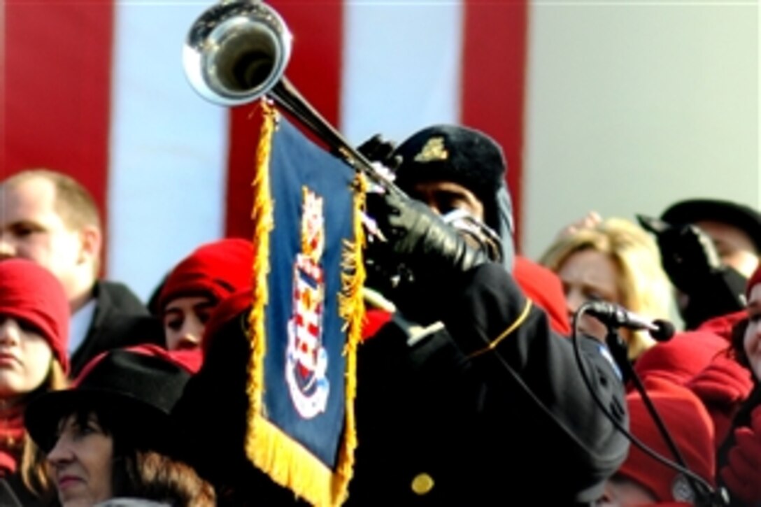 A U.S. Army Herald trumpeter stands and plays along the balcony railing on the inaugural reviewing stand, Jan. 20, 2009. The group delivered a fanfare at the U.S. Capitol during the 56th Presidential Inauguration in Washington, D.C. 