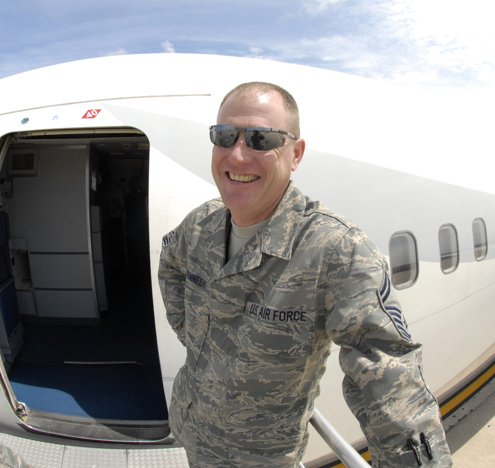 Senior Master Sgt. Rodney Kennedy waits for 442nd Fighter Wing reservists to board a passenger airplane in May 2008 for a flight to Bagram Air Base, Afghanistan.  Sergeant Kennedy, the 442nd Logistic Readiness Squadron's plans and integration superintendent, is responsible for getting deployed reservists to and from their Aerospace Expeditionary Force assignments.  (U.S. Air Force photo/Maj. David Kurle)