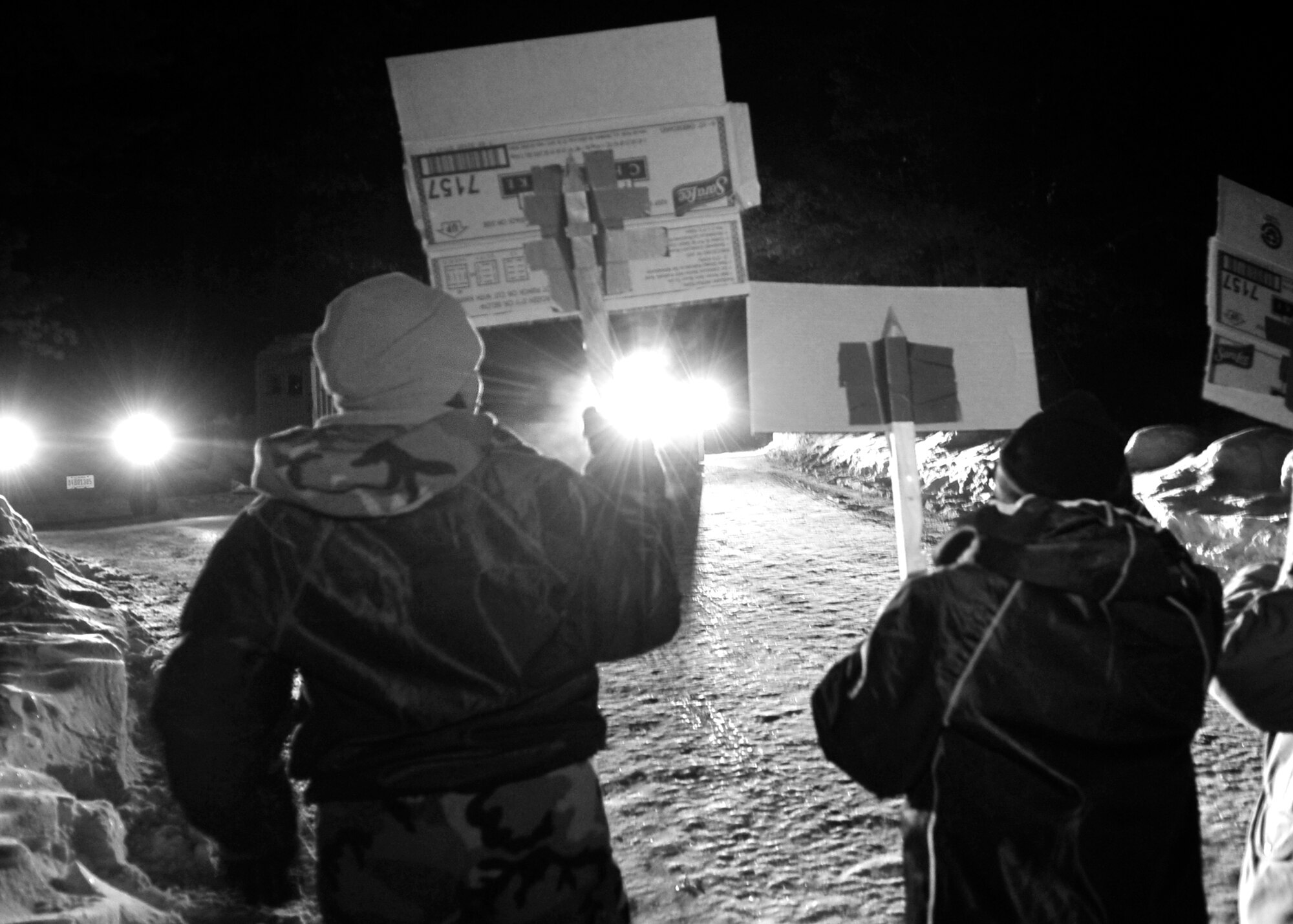 ALPENA, Mich. – Demonstrators wave signs and voice objections in order to protest operations at a simulated base in the Pacific, during an exercise in Alpena, Mich., Jan. 13. The demonstrators were actors made up of Airmen and civilians of both the 92nd and 141st Air Refueling Wings. (U.S. Air Force photo / Senior Airman Joshua Chapman)

