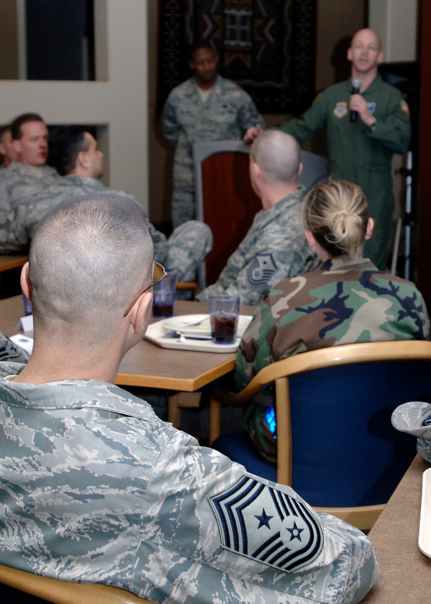 FAIRCHILD AIR FORCE BASE, Wash. – Chief Master Sgt. David Nordel, 92nd Air Refueling Wing command chief, listens to Col. Marshal Morrison, 92nd Operations Group commander, as he gives his closing remarks after the Diamond Sharp breakfast at the Warrior Dinning Facility Jan. 22. “We all know our mission would not be successful without these Airmen soaring to new heights every day. To all of our honorees, I want to say thank you for your commitment to integrity, service and excellence,” said Colonel Morrison. (U.S. Air Force photo / Airman 1st Class Melissa L. Barnett)

