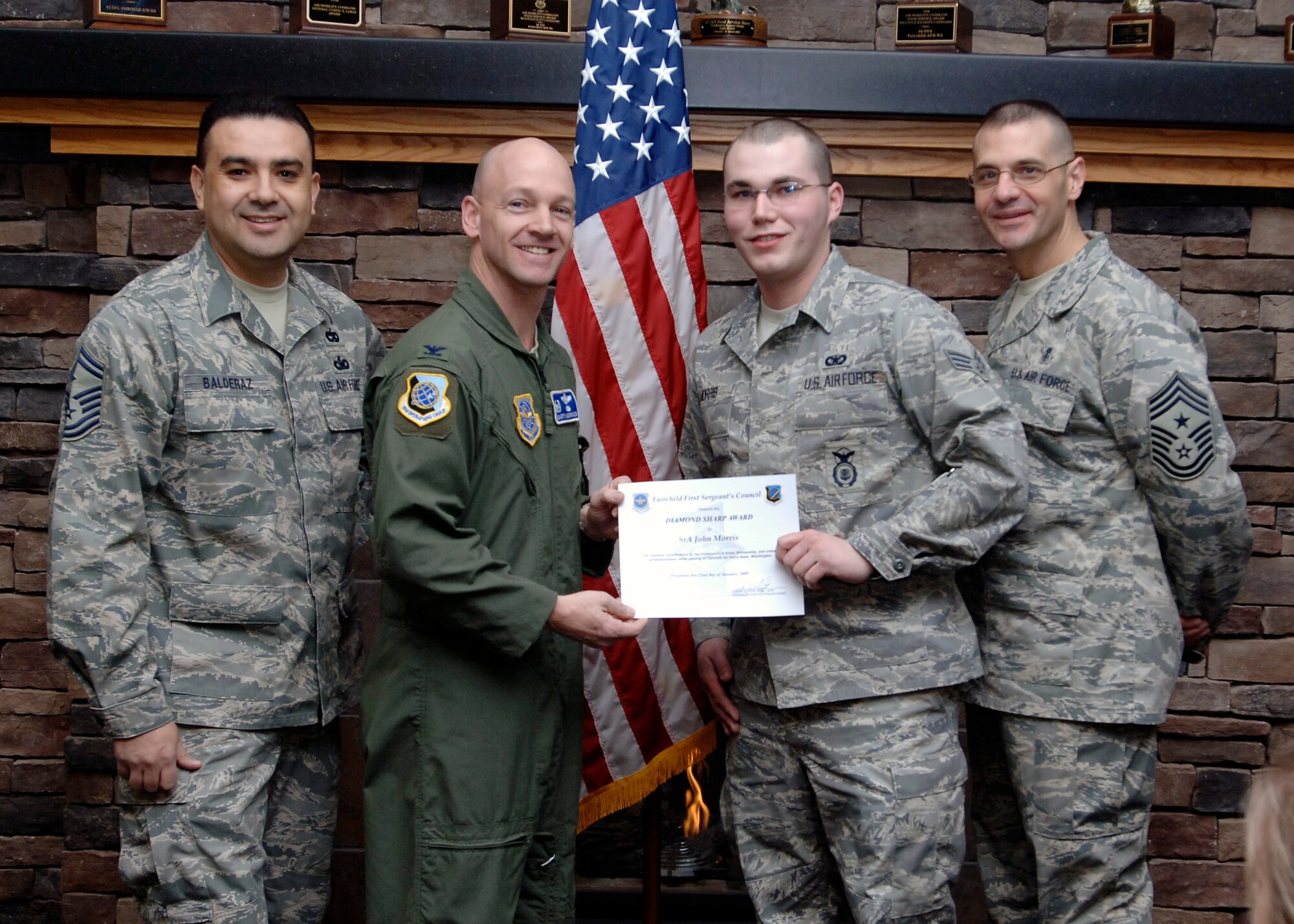 FAIRCHILD AIR FORCE BASE, Wash – Col. Marshal Morrison, 92nd Operations Group commander and Chief Master Sgt. David Nordel, 92nd Air Refueling Wing command chief, present Senior Airman John Morris, 92nd Security Forces Squadron patrolman, with the Diamond Sharp award Jan. 22. Senior Master Sgt. John Balderez, 92nd SFS first sergeant, nominated Airman Morris for displaying outstanding professionalism, impeccable appearance and a “can do” attitude. (U.S. Air Force photo / Airman 1st Class Melissa L. Barnett)