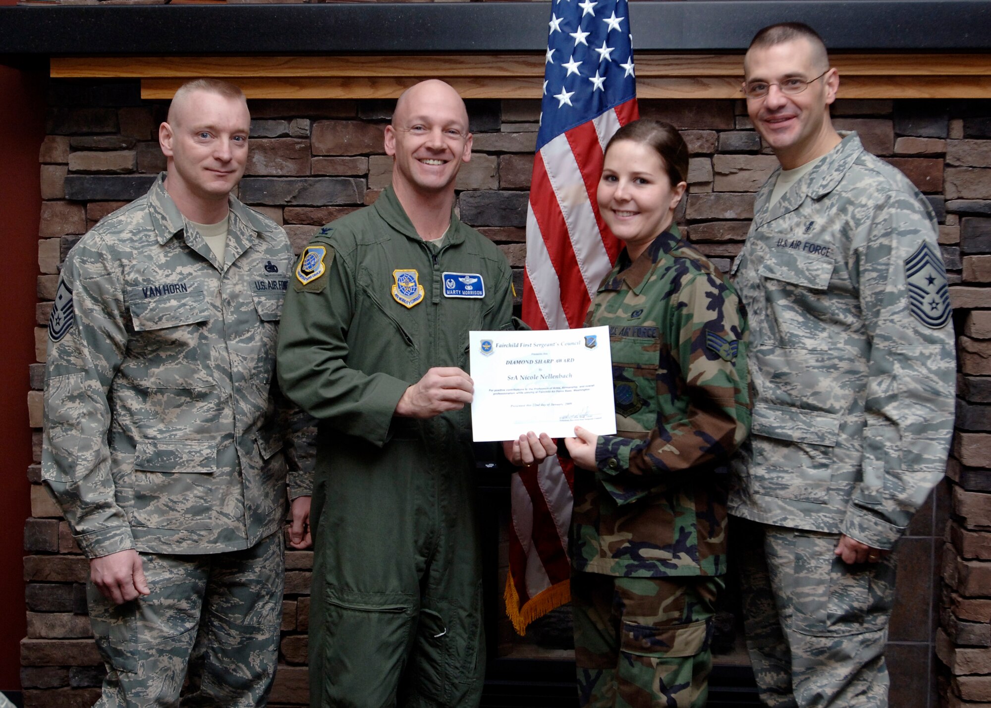 FAIRCHILD AIR FORCE BASE, Wash. – Col. Marshal Morrison, 92nd Operations Group commander, Chief Master Sgt. David Nordel, 92nd Air Refueling Wing command chief, and Master Sgt. Tim Vanhorn, 92nd Operations Support Squadron, first sergeant, present Senior Airman Nicole Nellenbach, 92nd OSS aircrew flight equipment journeyman, with the Diamond Sharp award at the Warrior Dinning Facility Jan. 22. The Diamond Sharp award is given to Airmen who strive for excellence, both on and off duty, in their community and their personal life. (U.S. Air Force photo / Airman 1st Class Melissa L. Barnett)