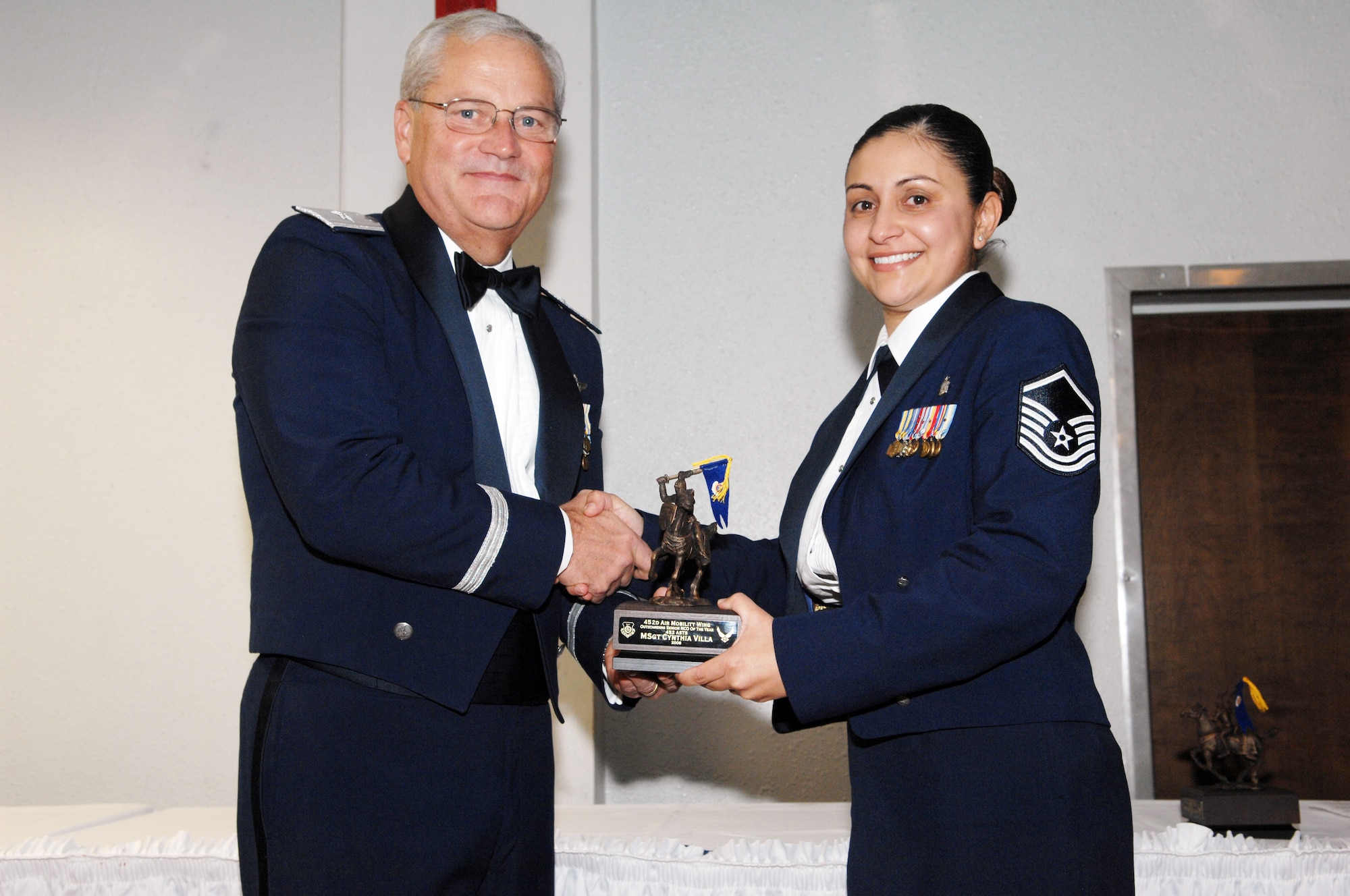 Master Sgt. Cynthia Villa of the 452 ASTS recieves her award for Senior NCO  of the Year. Jan. 10,  2009 from Brig. Gen. James L. Melin, commander, 452nd Air Mobility Wing.