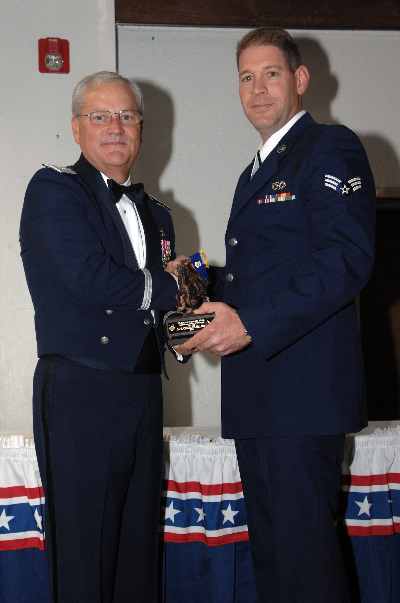 Brig. Gen. James L. Melin, commander, 452nd Air Mobility Wing, presents the Airman of the Year award to Senior Airman Charles M. Elliott, 452nd Air Mobility Wing.