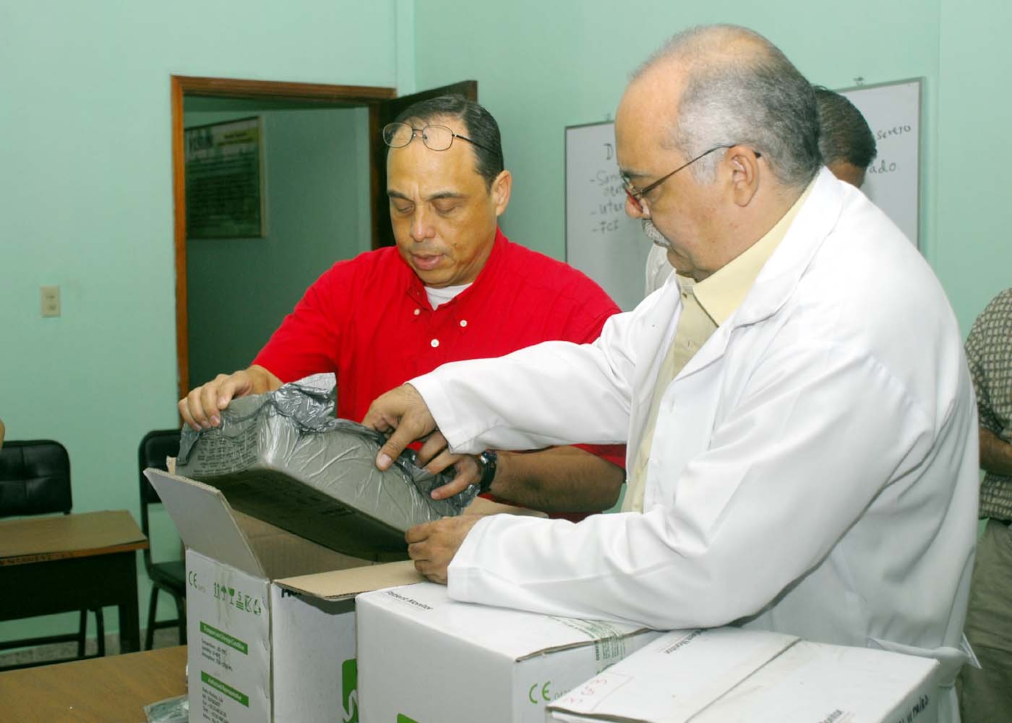 SOTO CANO AIR BASE, Honduras - Dr. Guillermo Saenz, Joint Task Force-Bravo Medical Element liaison officer, unpacks a vital signs monitor with Dr. Jose Fernando El Cantara at Santa Teresa Hospital in Comayagua, Honduras Jan. 21.  The JTF-B doctor worked with the U.S. Military Group in Tegucigalpa to arrange the donation of $10,000 worth of equipment to the pediatric unit at Santa Teresa.  (US Air Force photo/Tech. Sgt. Rebecca Danét)