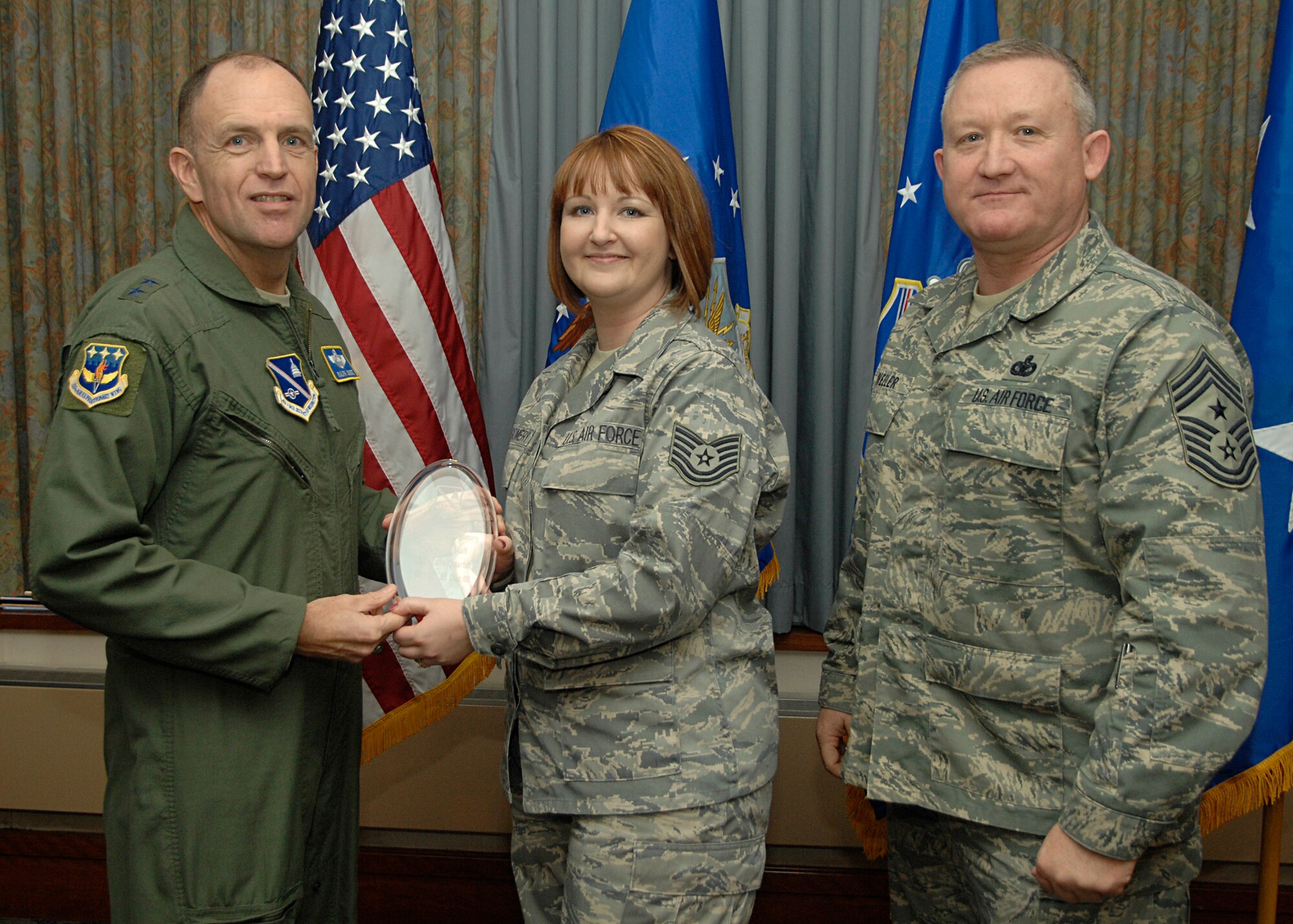 Tech. Sgt. Selinda Montgomery accepts the award for "Best NCO of the Quarter" for her work in the AFDW Command Section. 