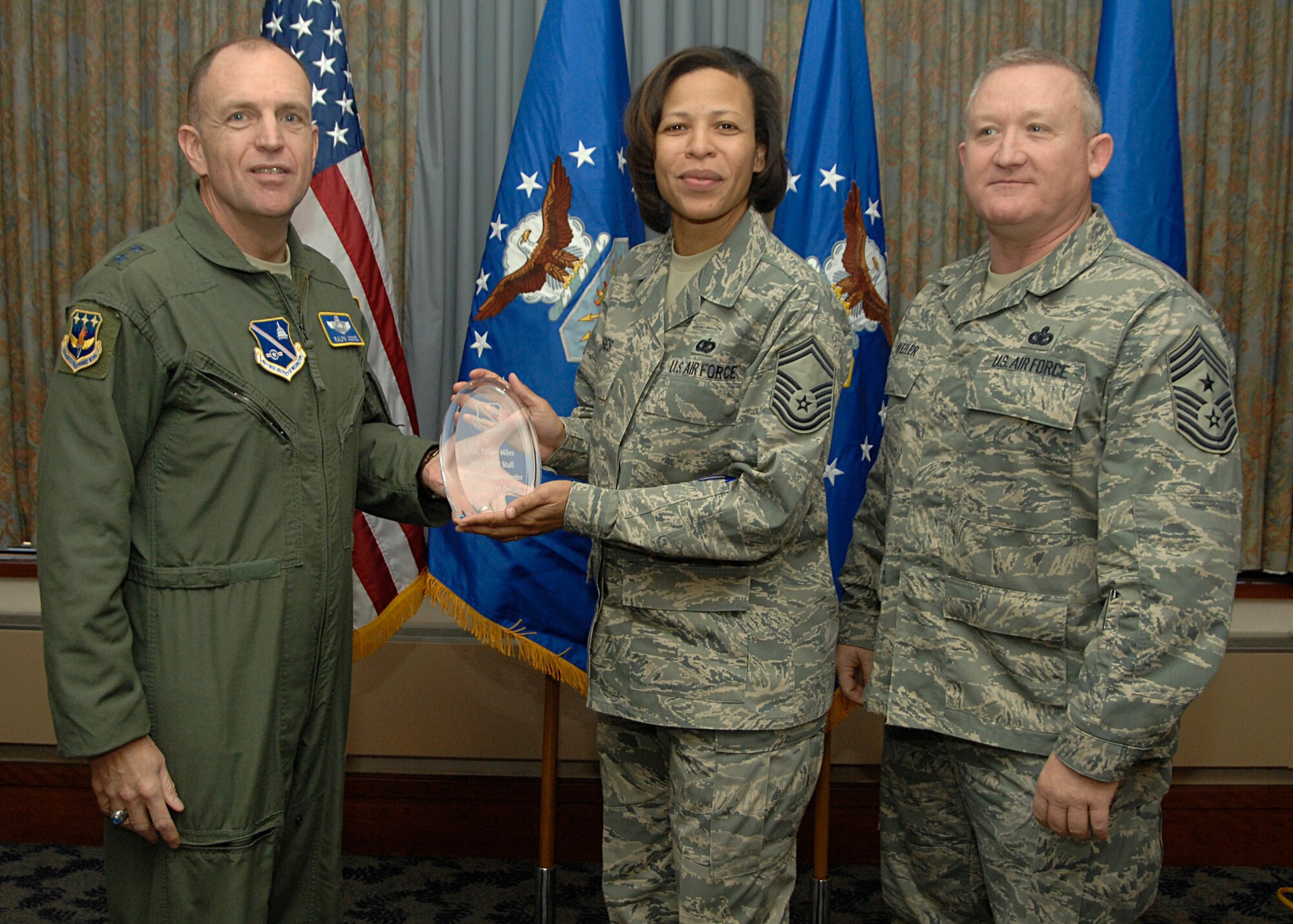 AFDW 1st Sgt. SMSgt. Yvette Hodges (center) accepts the award for "Best Airman of the Quarter" on behalf of Airman Tiffany Miles, AFDW Knowledge Operations Center.
