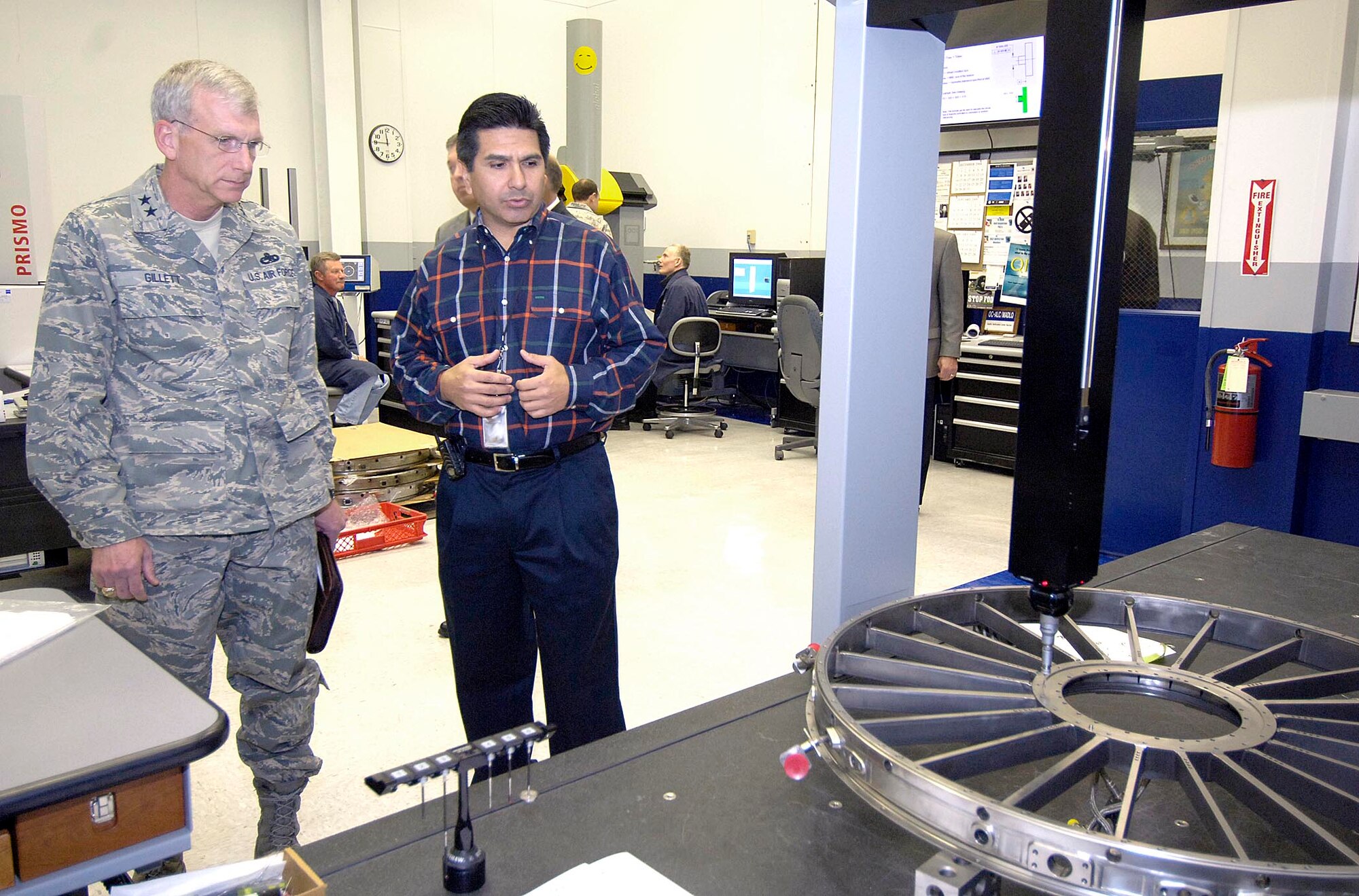 Maj. Gen. P. David Gillett Jr. tours areas of the 76th Maintenance Wing Jan. 14, during his orientation to Tinker, days after assuming command of the Oklahoma City Air Logistics Center. Ron Camacho, chief of the quality verification center, describes the use of a Coordinate Measuring Machine on an F100 engine inlet fan case in the Metrology Laboratory. As part of the orientations, General Gillett was also briefed at the 327th Aircraft Sustainment Wing on Jan. 16. (Air Force photo/Margo Wright)