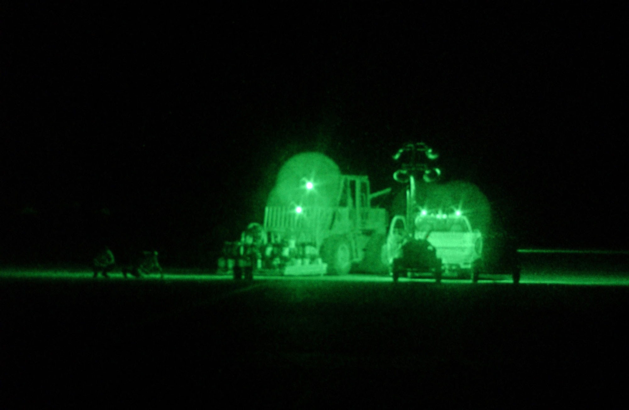 Air Force personnel with the 1st Expeditionary RED HORSE Group (ERHG) take advantage of the cool night air to repair sections of the runway at Tallil AB, Iraq, in support of Operation Iraqi Freedom. (U.S. Air Force photo)