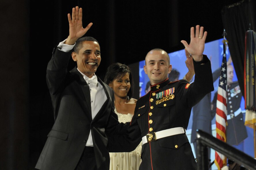 President Barack Obama and U.S. Marine Sgt. Elidio Guillen wave to the crowd at the Commander in Chief's Ball Jan. 20, 2009 in downtown Washington, D.C. More than 5,000 men and women in uniform are providing military ceremonial support to the presidential inauguration, a tradition dating back to George Washington's 1789 inauguration. (U.S. Air Force photo/Senior Airman Kathrine McDowell)