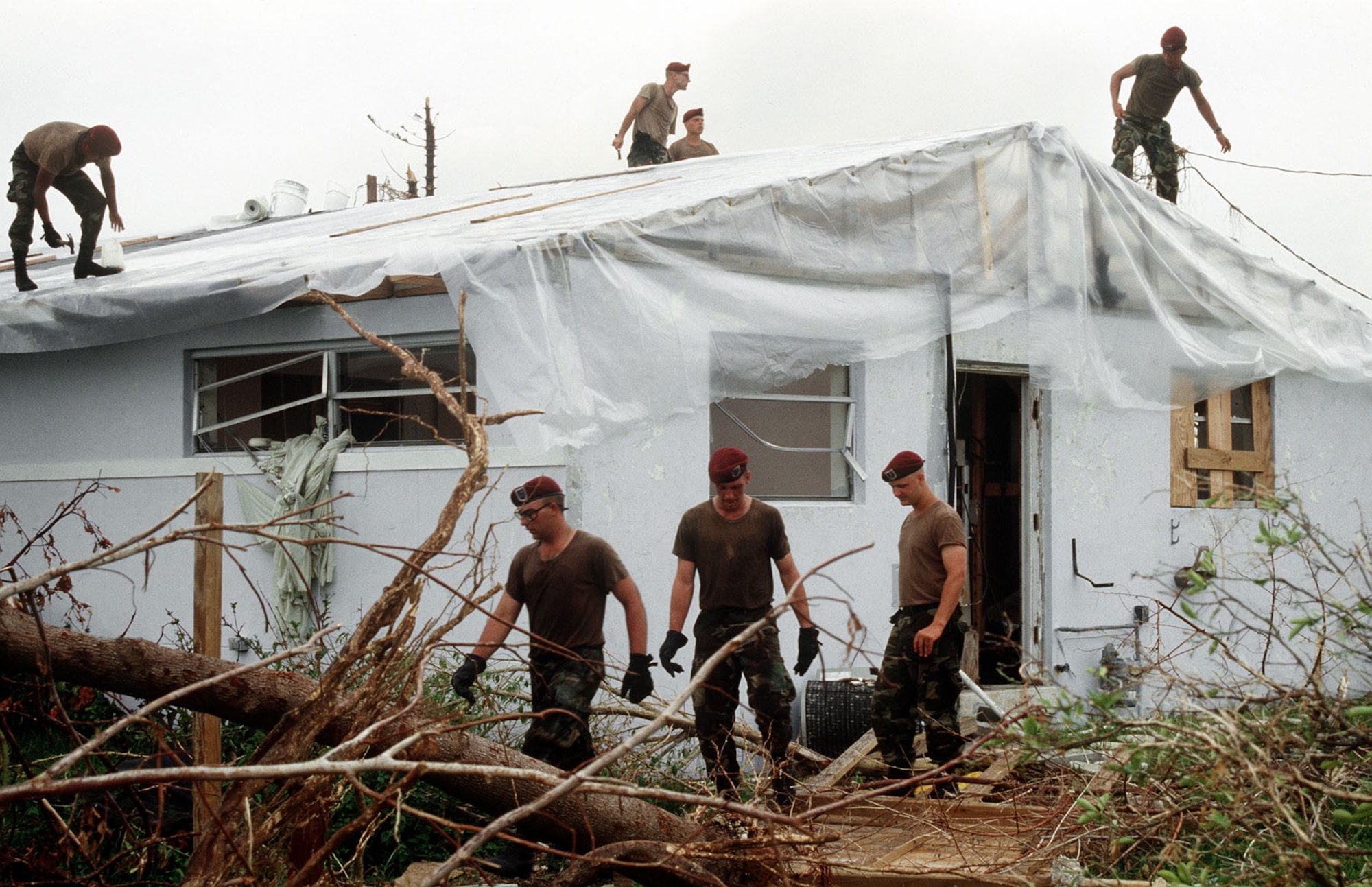 Members of the 202nd RED HORSE Civil Engineering Squadron repair the roof on a foster child care facility in the aftermath of Hurricane Andrew in 1992. (U.S. Air Force photo)