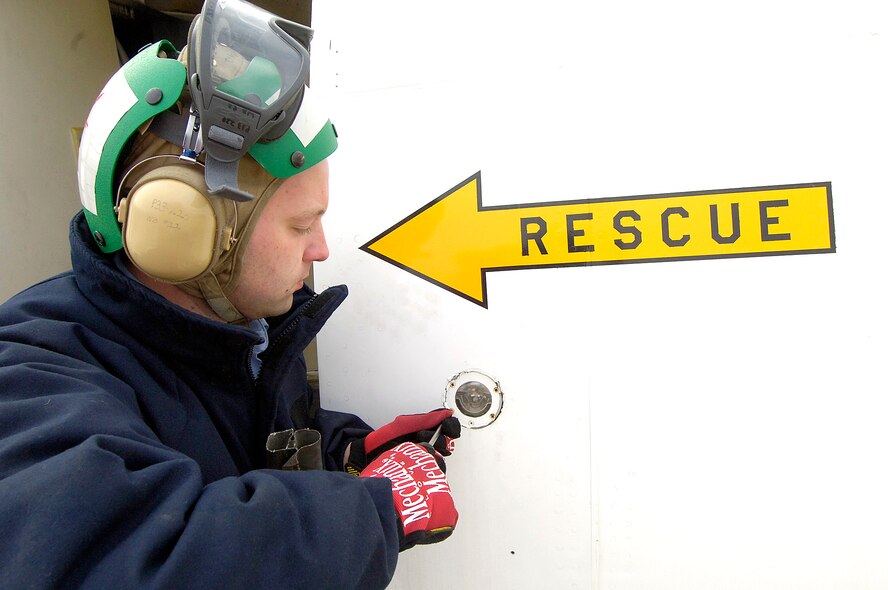 Flightline workers wish they were “rescued” from the cold. But, a biting wind chill of 11 degrees, blowing at 14 mph, doesn’t slow down Petty Officer 2nd Class Ian Stewart, an aviation electrician who works on an E-6 aircraft’s exterior lights during maintenance.  Aircraft maintainers are on the job regardless of the weather, keeping Navy and Air Force aircraft ready for the skies. (Air Force photo/Margo Wright)