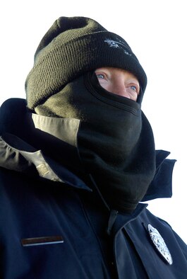 Tinker gate guard David Brownlee offers warm greetings to motorists on a bitterly cold morning. “Most people appreciate what you do,” says Mr. Brownlee.  Wearing multiples of everything and grateful to be working a gate with space heaters, the guard doesn’t let the temperature cool his sunny greeting.  “A good attitude can make a difference for people and set the tone for their day,” he said. (Air Force photo/Margo Wright)