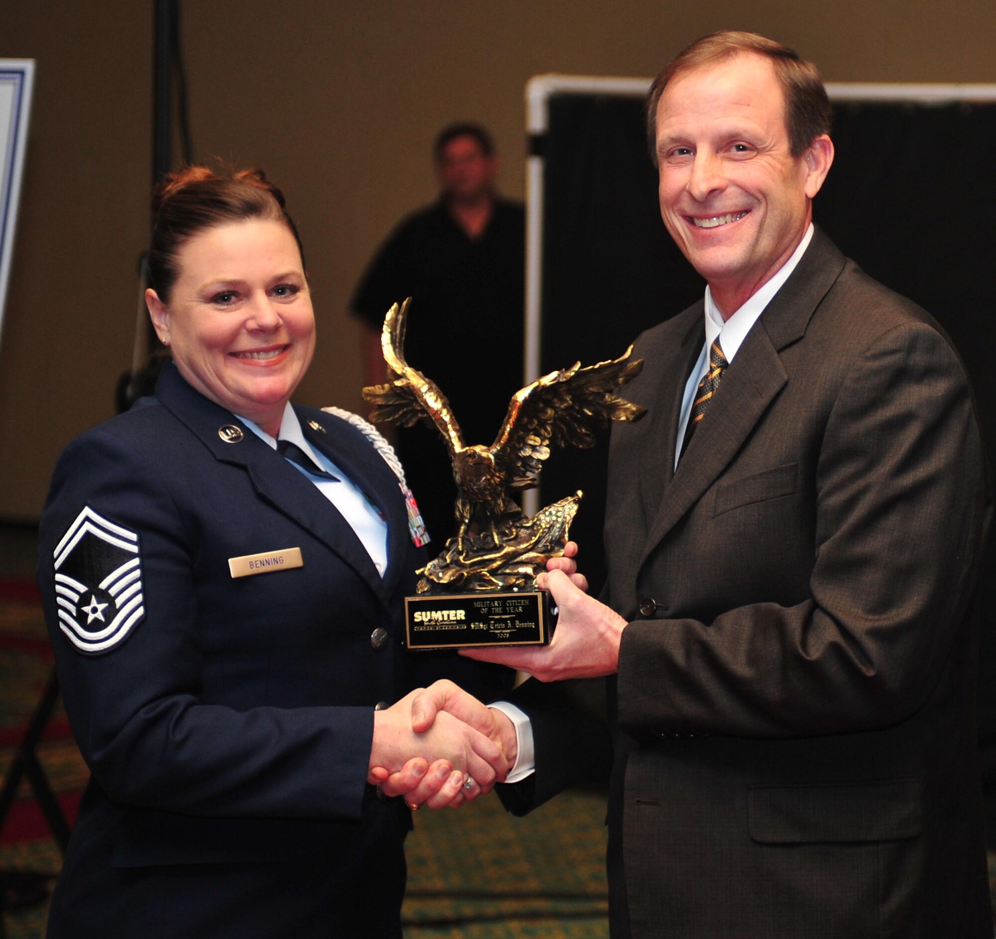 SHAW AIR FORCE BASE, S.C. -- Senior Master Sgt. Tricia Benning receives the  Military Citizen of the Year award from Mr. John Jones Jan. 17 in Myrtle Beach, S.C.  Sgt. Benning was the chapter president and now senior advisor for the Air Force Sergeants Association chapter at Shaw. She partnered with the Crosswell Children's Home, supported 12 events and managed more than 240 volunteers for the benefit of the children. (U.S. Air Force photo/Staff. Sgt Patrick Mitchell)