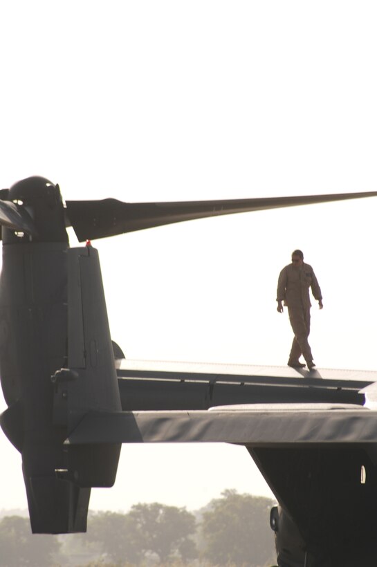 An Airman from the 1st Special Operations Helicopter Maintenance Squadron walks the wing of a CV-22 Osprey during a maintenance examination in Mali, Africa, Nov. 12, 2008. Four Ospreys from the 8th Special Operations Squadron and roughly 100 Airmen from the 1st Special Operations Wing deployed to Africa in support of Exercise Flintlock. (Photo by Sgt. Kieran Cuddihy)