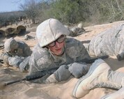 Air Force basic military trainees low crawl during Basic Expeditionary Airmen Skills Training. At the BEAST site, trainees face a series of increasingly difficult exercise events under simulated, realistic combat conditions. Trainees hone war skills such as basic self-defense, integrated base defense, self aid and buddy care and improvised explosive device recognition and response. (USAF photo by Alan Boedeker)                          