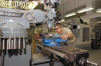 12/29/2008 - Airman 1st Class Jeremiah Jackson mills a gas carrier key staking fixture for the M16A2 at the Lackland gunsmith shop. (USAF photo by Alan Boedeker) 