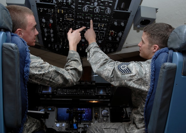Tech. Sgt. Cameron Leslie shows Airman Basic Benjamin Oehlke the basics of operating C-17 flight controls on Charleston AFB Jan. 20. For fiscal year 2008, five instructors from the training detachment taught a total of 5,678 hours, graduating 52 new C-17 crew chiefs. Sergeant Leslie is an instructor and Airman Oehlke is in training at the 373rd Training Squadron Detachment 5. (U.S. Air Force photo/Senior Airman Katie Gieratz) 