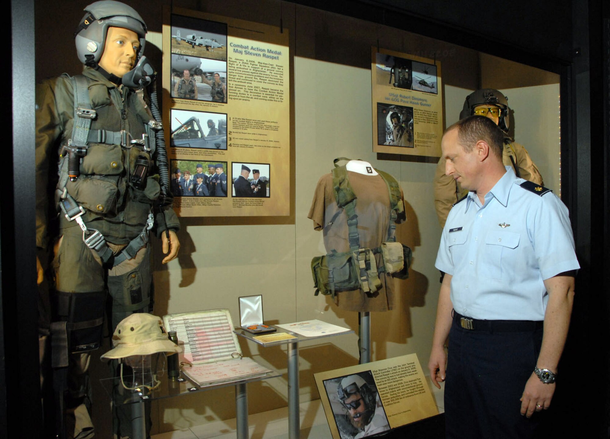 Maj. Steve Raspet looks at the mannequin that represents him and some of the artifacts he donated as part of the new "Warrior Airmen" exhibit Jan. 13 at the National Museum of the U.S. Air Force. Major Raspet, the 12th Operations Group T-6A Texan II standards and evaluation branch chief and instructor pilot at Randolph Air Force Base, Texas, was one of the first Airmen to earn the Air Force Combat Action Medal after he and his co-pilot provided air cover and close-air support during a joint Afghan army and U.S. Army operation while deployed in 2006. (U.S. Air Force photo/Jeff Fisher) 
