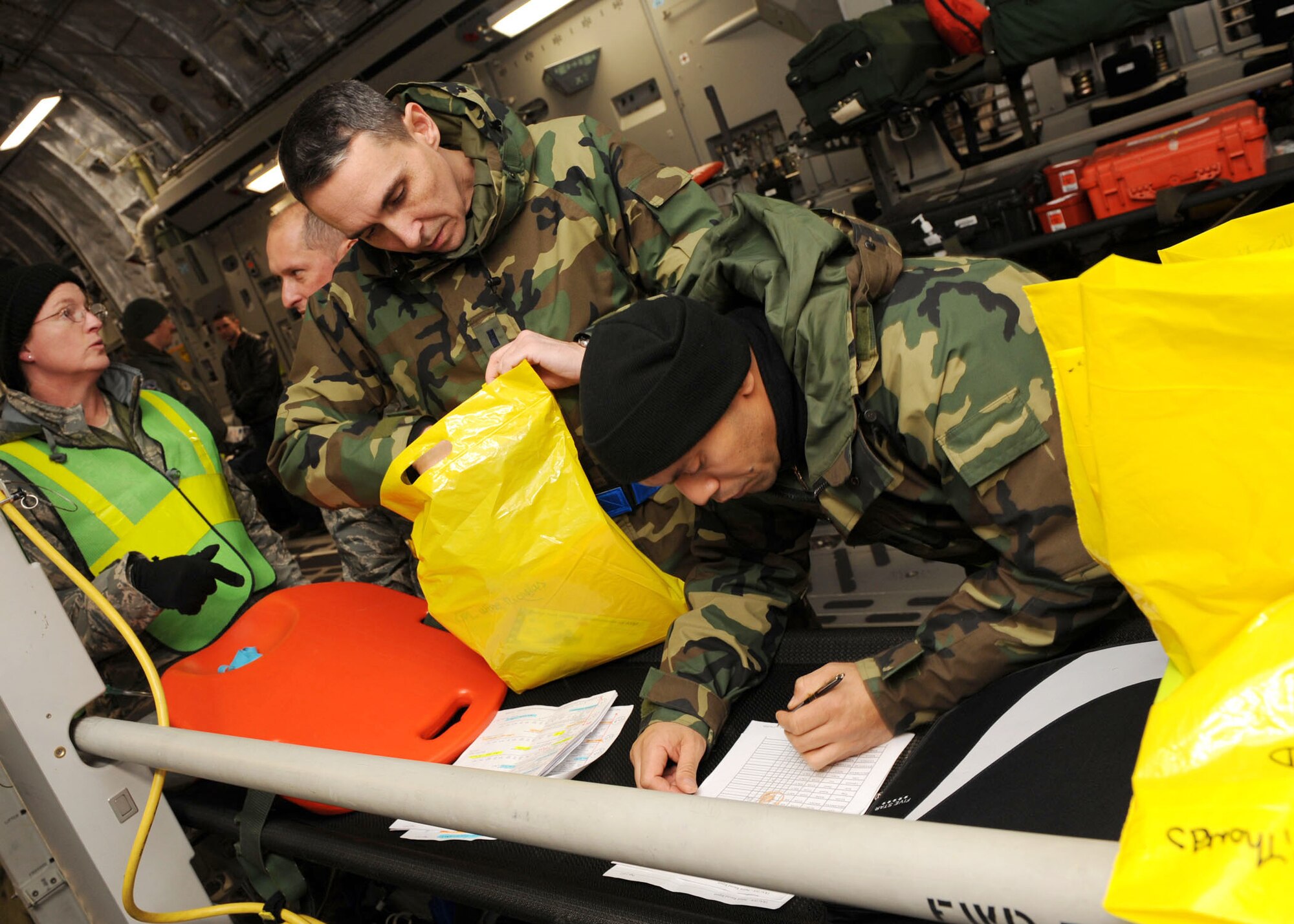 SCOTT AIR FORCE BASE, Ill. -- During an aeromedical evacuation mission, nurses and crew members of the transporting aircraft are required to evaluate the profiles and medical records of the patients before signing them over to the receiving unit. The process is performed very quickly because it has to be completed prior to moving any patients and as a result, any delays can severely disrupt the flight schedule as well as treatment of the patients.  (U.S. Air Force photo/Senior Airman Jonathan Lovelady) 