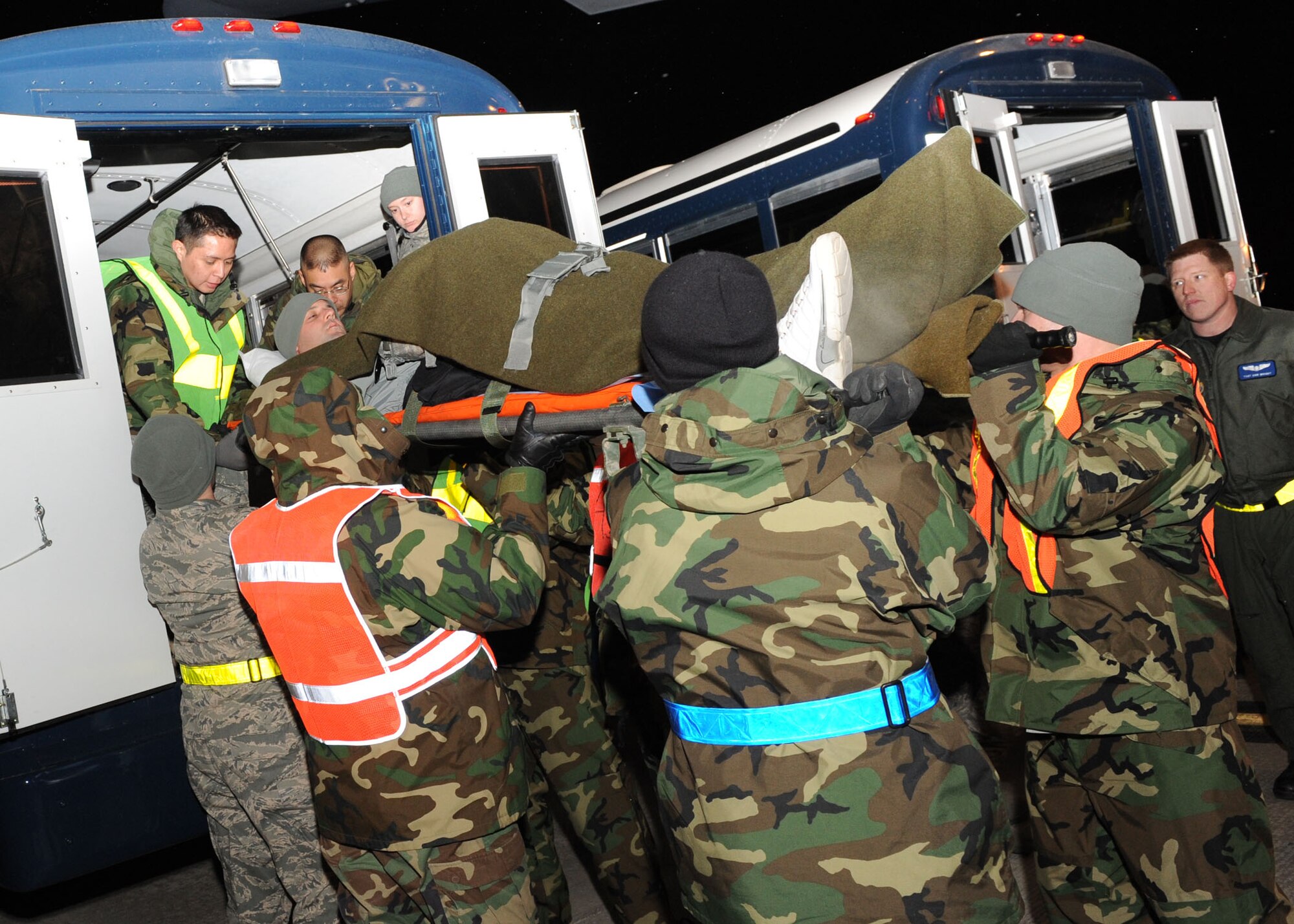 SCOTT AIR FORCE BASE, Ill. -- Members of the 375th Medical Group Aeromedical Staging Facility and volunteers from Scott lift a litter patient onto a bus that will transport him to the ASF were he will be treated and kept as comfortable before departing for his next stop on his route home. (U.S. Air Force photo/Senior Airman Jonathan Lovelady) 