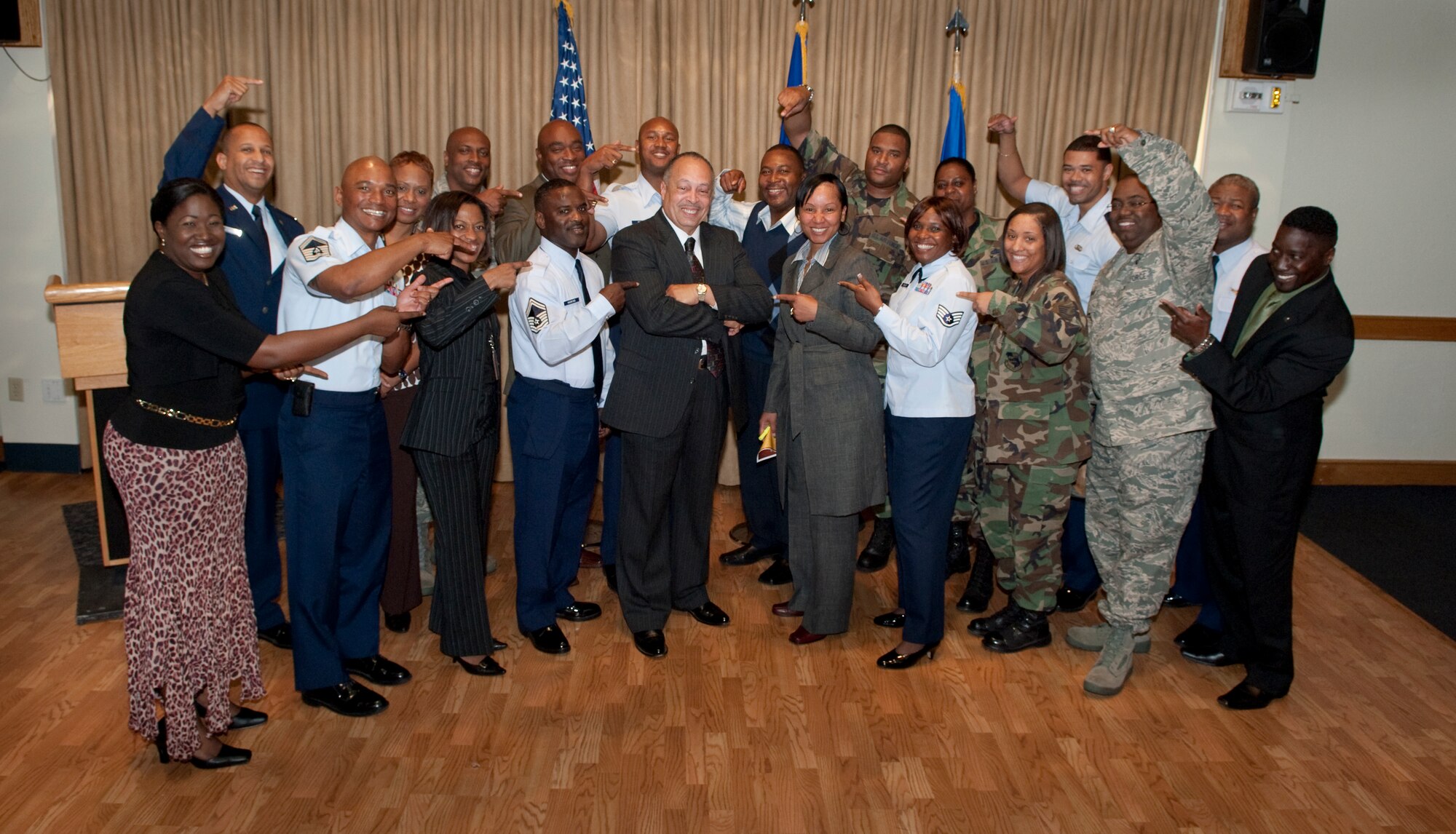 All hands point to Army Col. (ret.) Nathan Thomas (center, arms crossed), who served as the keynote speaker at the Dr. Martin Luther King Memorial Luncheon held Jan. 16 at The Tides.

"Without the work of Dr. Martin Luther King and others, we may never have had a Voters Rights Act," he said. "Dr. King was a great, great man." (U.S. Air Force photo by Jim Laviska)