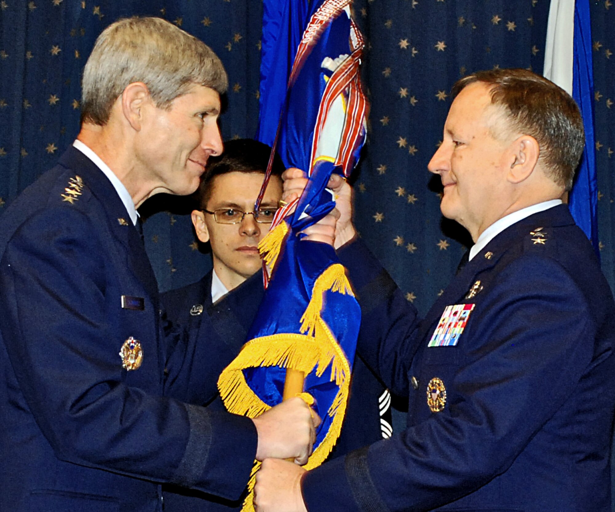 Air Force Chief of Staff Gen. Norton Schwartz hands the Air Force Safety Center flag to Maj. Gen. Frederick F. Roggero. General Roggero assumed command of the Air Force Safety Center here Jan. 13 during a ceremony at the Mountain View Club. U.S. Air Force Photo by Dennis Carlson