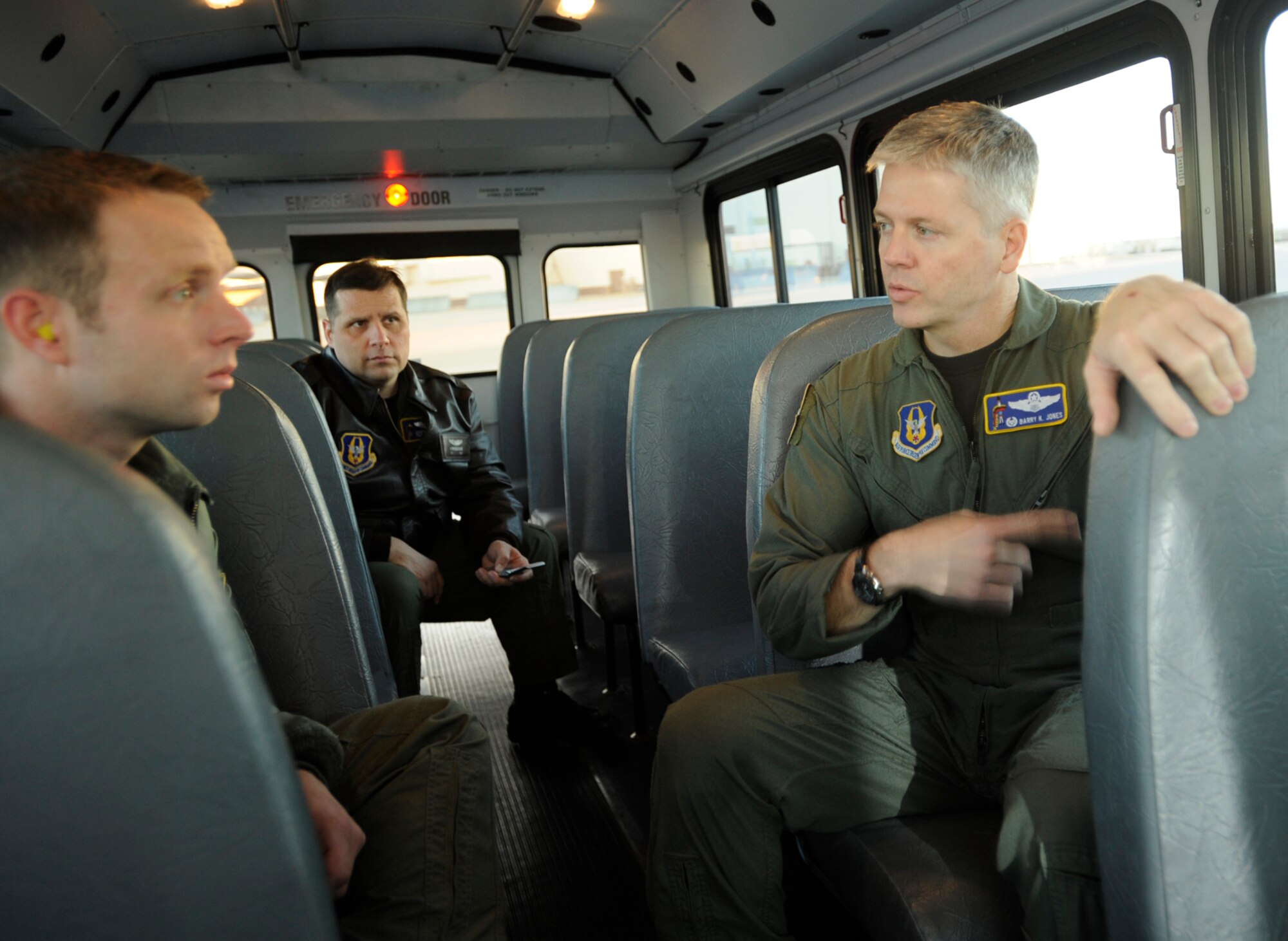 Lt. Col. Barry Jones talks with Capt. Keith "Kip" Anderson (far left) and Tech. Sgt. Kevin Bouchard during a bus ride to the flightline at McConnell Air Force Base, Kan. The three KC-135 Stratotanker crew members flew on an aerial refueling mission together in early January. Colonel Jones is a KC-135 pilot and commander of the 931st Operations Support Flight. Captain Anderson, also a pilot, and Sergeant Bouchard, KC-135 boom operator, are assigned to the 18th Air Refueling Squadron, the flying unit of the 931st Air Refueling Group. The 931st is an Air Force Reserve unit at McConnell. (U.S. Air Force photo/Tech. Sgt. Jason Schaap)    