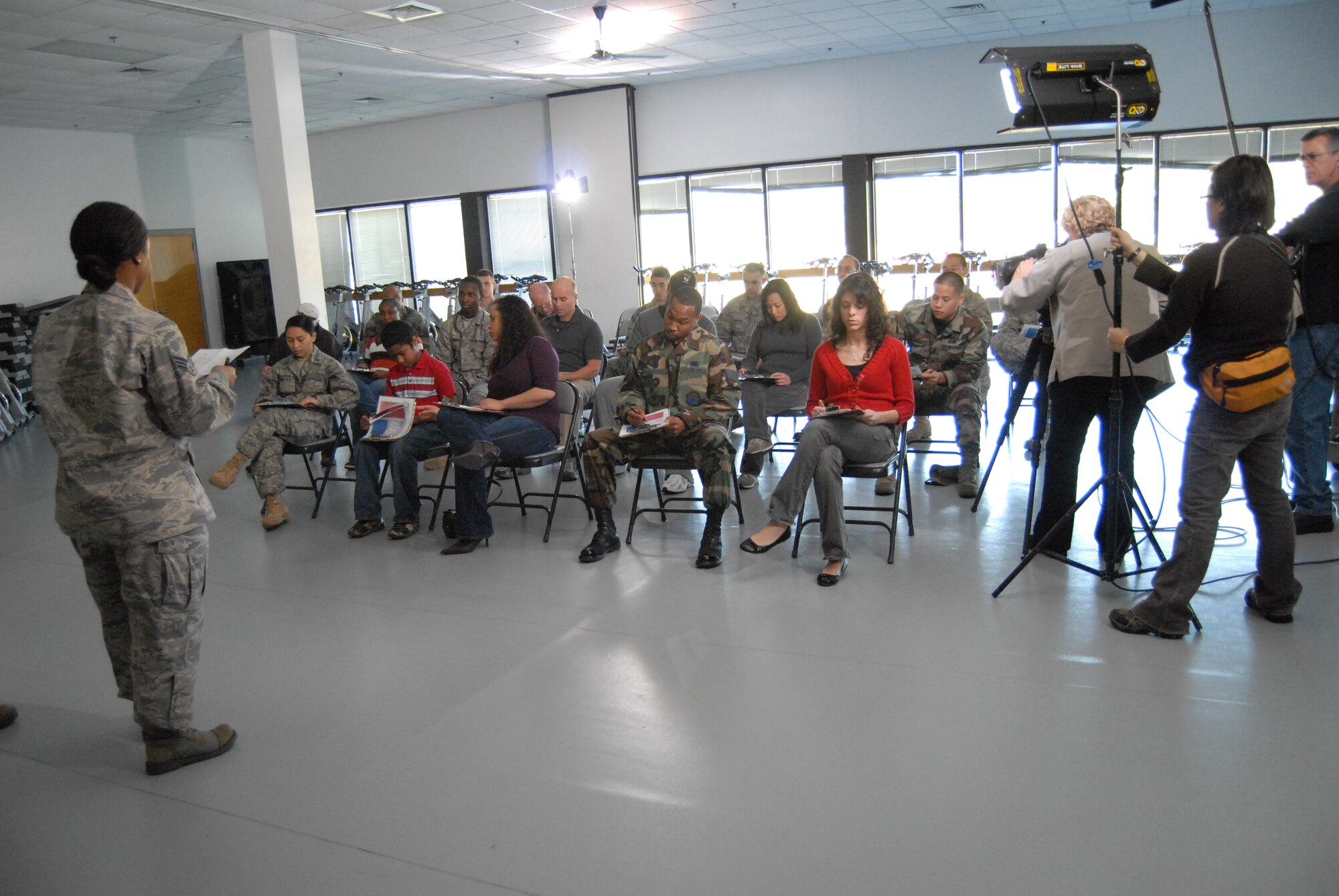 Senior Airman Monise Butler, 43rd Aerospace Medicine Squadron, conducts a patient briefing during a fictional situation involving a pneumonic plague breakout. Members of Pope volunteered to play different roles for this DoD web-based training video, which serves to prepare people in case of a real life emergency. (U.S. Air Force Photo by Airman 1st Class Mindy Bloem)