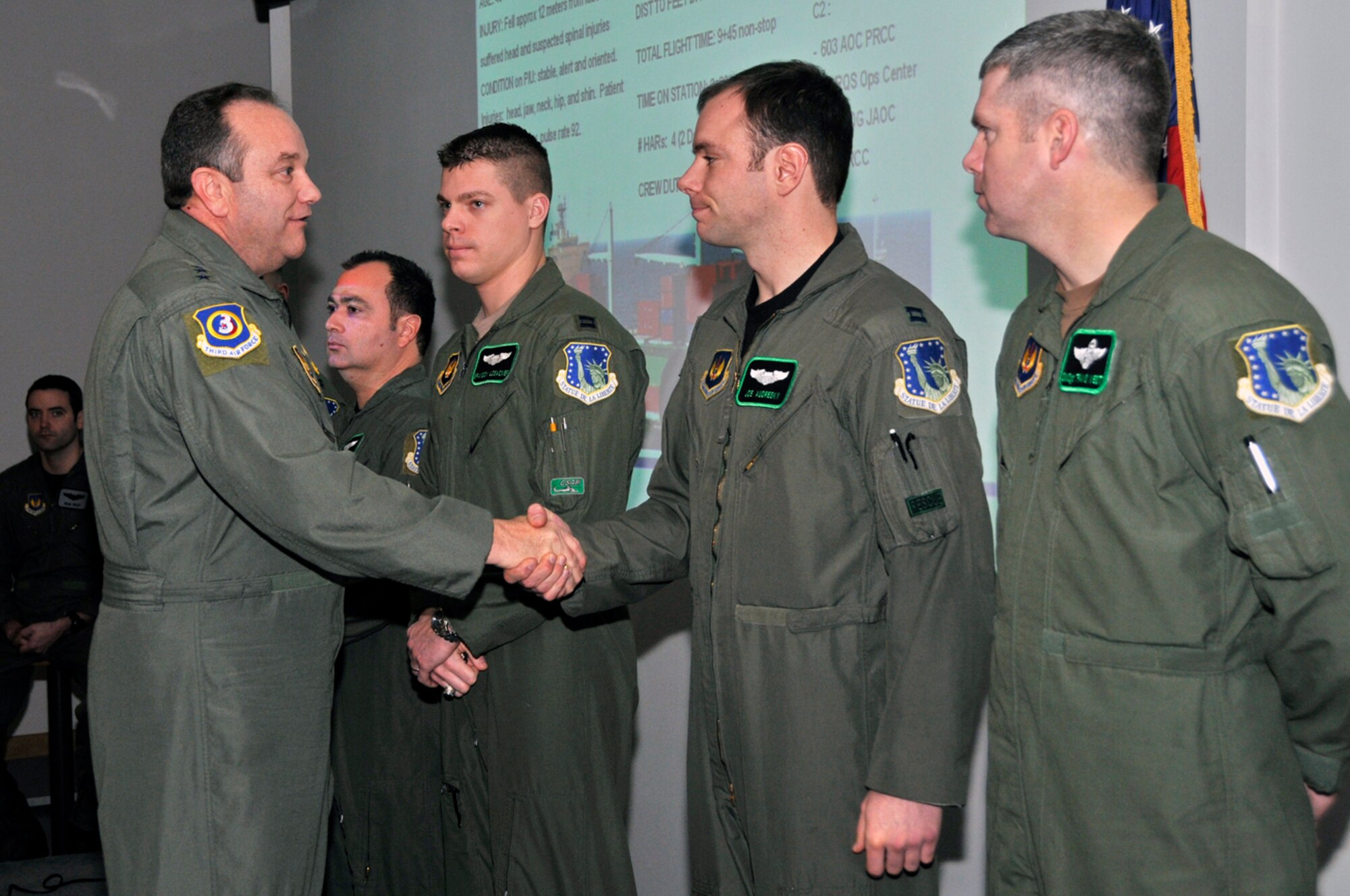 During a recent base visit, Lt. Gen. Phil Breedlove, 3rd Air Force commander, coins Capt. Joseph Andresky, 56th Rescue Squadron, and other members of his unit Jan. 8 at RAF Lakenheath, England, for a job well done during a rescue at sea in early December. The 56th RQS flew some 300  miles off the coast of Ireland to rescue a Burmese sailor nearly fatally injured on a cargo vessel. (U.S. Air Force photo by Airman 1st Class Perry Aston)