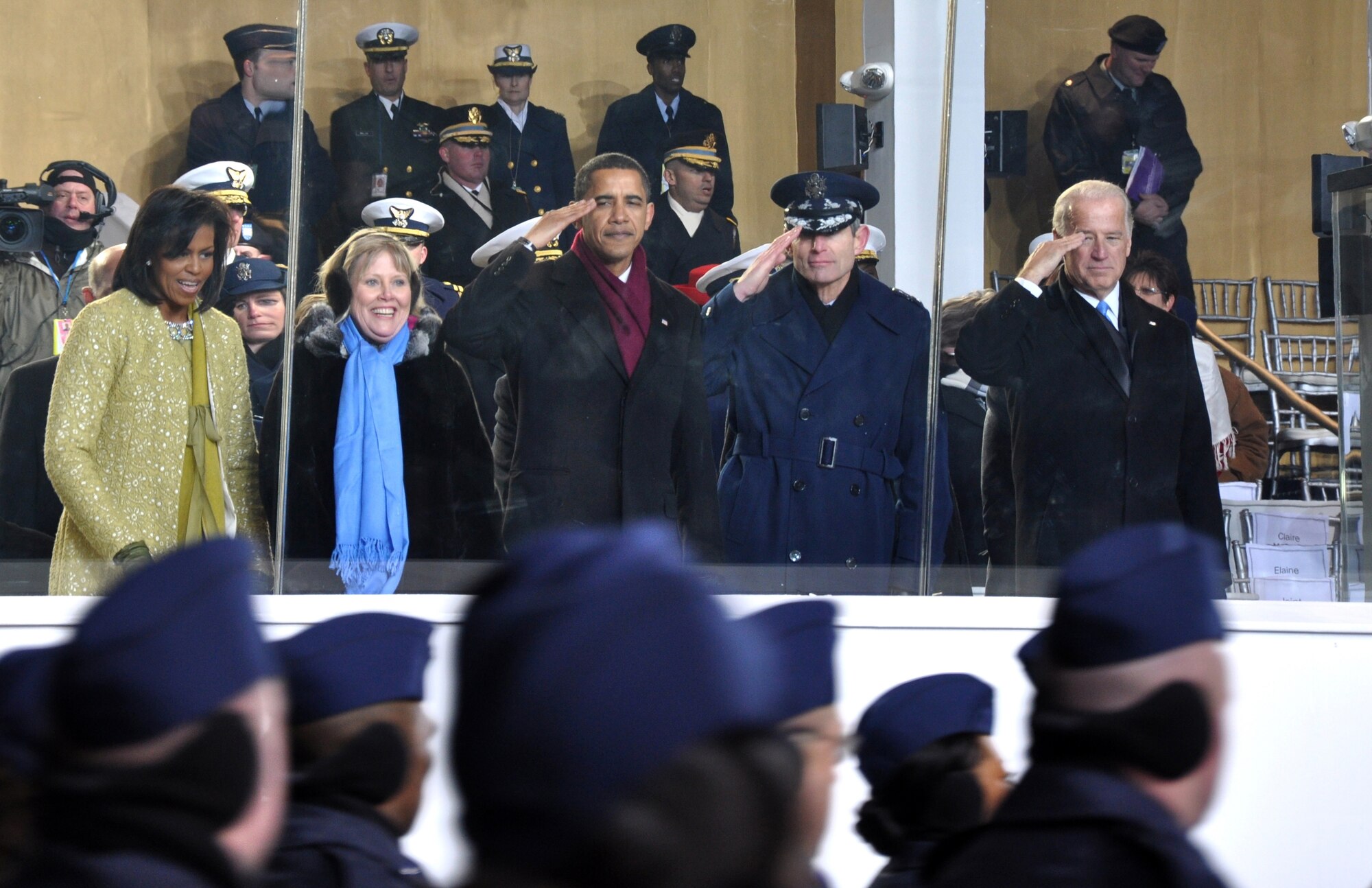 From the presidential reviewing stand, First Lady Michelle Obama, an unidentified woman, President Barack Obama, Air Force Chief of Staff Gen. Norton A. Schwartz, and Vice President Joe Biden salute the Air Force Reserve Command's 459th Air Refueling Wing during the presidential inaugural parade Jan. 20, 2009. The 90-member, all-volunteer marching unit is based at Andrews Air Force Base, Md. (U.S. Air Force photo/Tech. Sgt. Amaani Lyle)