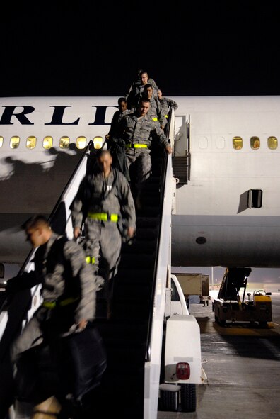 Airmen from Dyess Air Force Base, Texas, disembark from the aircraft that brought them to their deployment destination, Jan. 21, 2009, at an undisclosed location in Southwest Asia.  The personnel have arrived to relieve Airmen from Ellsworth Air Force Base, S.D., who have been flying and supporting B-1B bomber missions in support of Operation Iraqi and Enduring Freedom and Joint Task Force- Horn of Africa.  (U.S. Air Force Photo by Airman 1st Class Andrew Satran/Released)