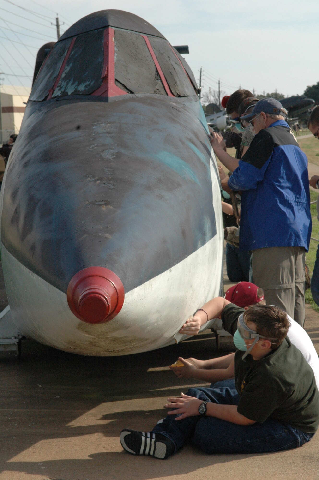 Texas Boy Scout Troop 531 performs a community service project during their visit to Barksdale, the second weekend of January. They started a three phase project to restore the B-52 "Hustler" located at the outdoor 8th Air Force museum which will be continued in February by another Boy Scout Troop. (U.S. Air Force photo/Mrs. Betty Stephens) 