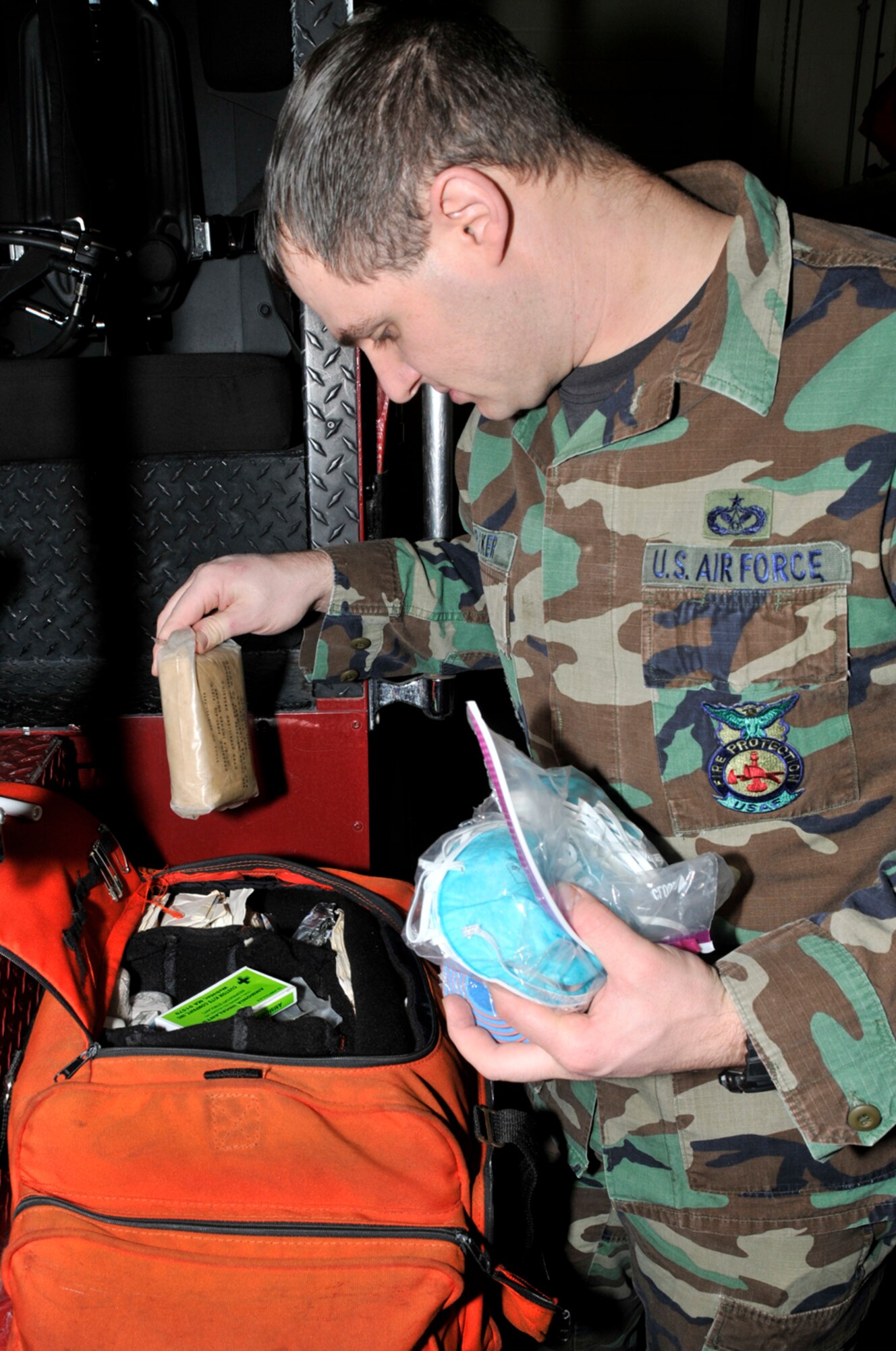 Tech. Sgt. Daniel Parker, 48th Civil Engineer Squadron firefighter, inspects their Basic Life Saving (BLS) medical bag Jan. 22 at RAF Lakenheath, England. All of RAF Lakenheath's fire apparatus have BLS medical bags onboard. (U.S. Air Force photo by Airman 1st Class Perry Aston)