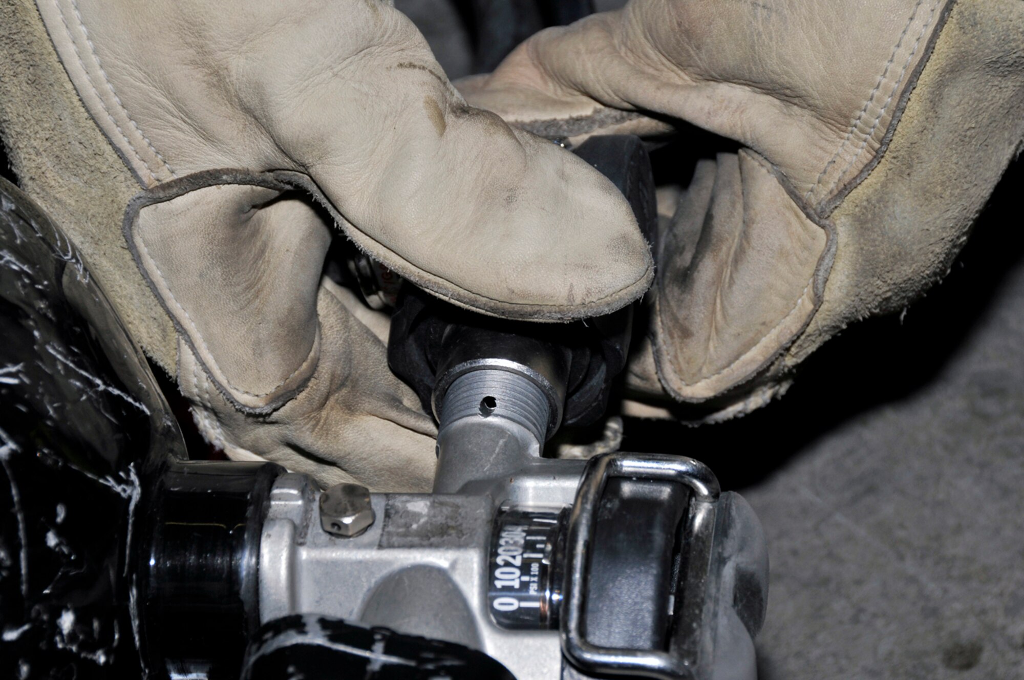 Tech. Sgt. Daniel Parker, 48th Civil Engineer Squadron firefighter, re-attaches the valve to his air cylinder after inspecting his self contained breathing apparatus (SCBA) Jan. 22 at RAF Lakenheath, England. Sergeant Parker inspects his SCBA at the start of each shift. (U.S. Air Force photo by Airman 1st Class Perry Aston) 