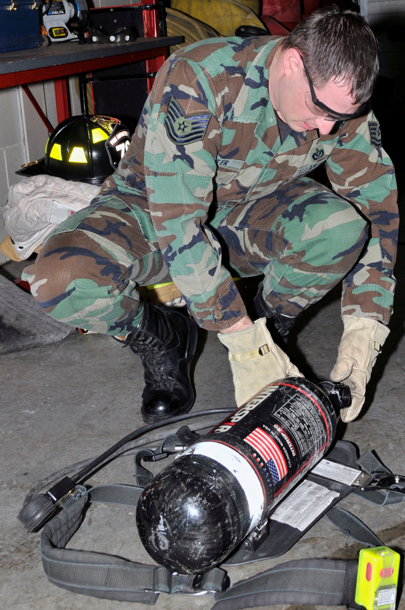 Tech. Sgt. Daniel Parker, 48th Civil Engineer Squadron firefighter, inspects his self contained breathing apparatus (SCBA) Jan. 22 at RAF Lakenheath, England. SCBA's protect the wearer from breathing in superheated air, smoke and other dangerous gases that are found in fire. (U.S. Air Force photo by Airman 1st Class Perry Aston)