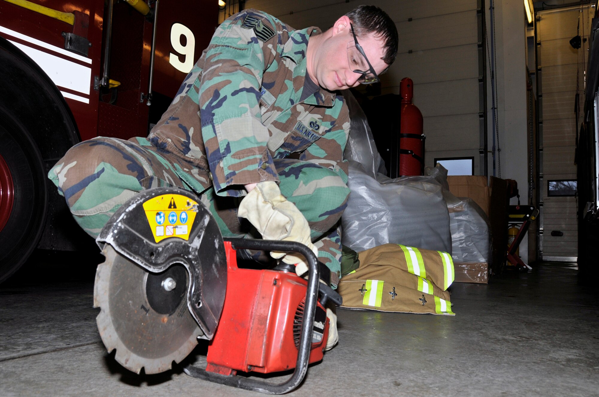 Tech. Sgt. Daniel Parker, 48th Civil Engineer Squadron firefighter, checks the fuel level in the K-12 fire rescue saw Jan. 22 at RAF Lakenheath, England. The 95cc K-12 saw is capable of cutting through reinforced concrete and steel.  (U.S. Air Force photo by Airman 1st Class Perry Aston) 