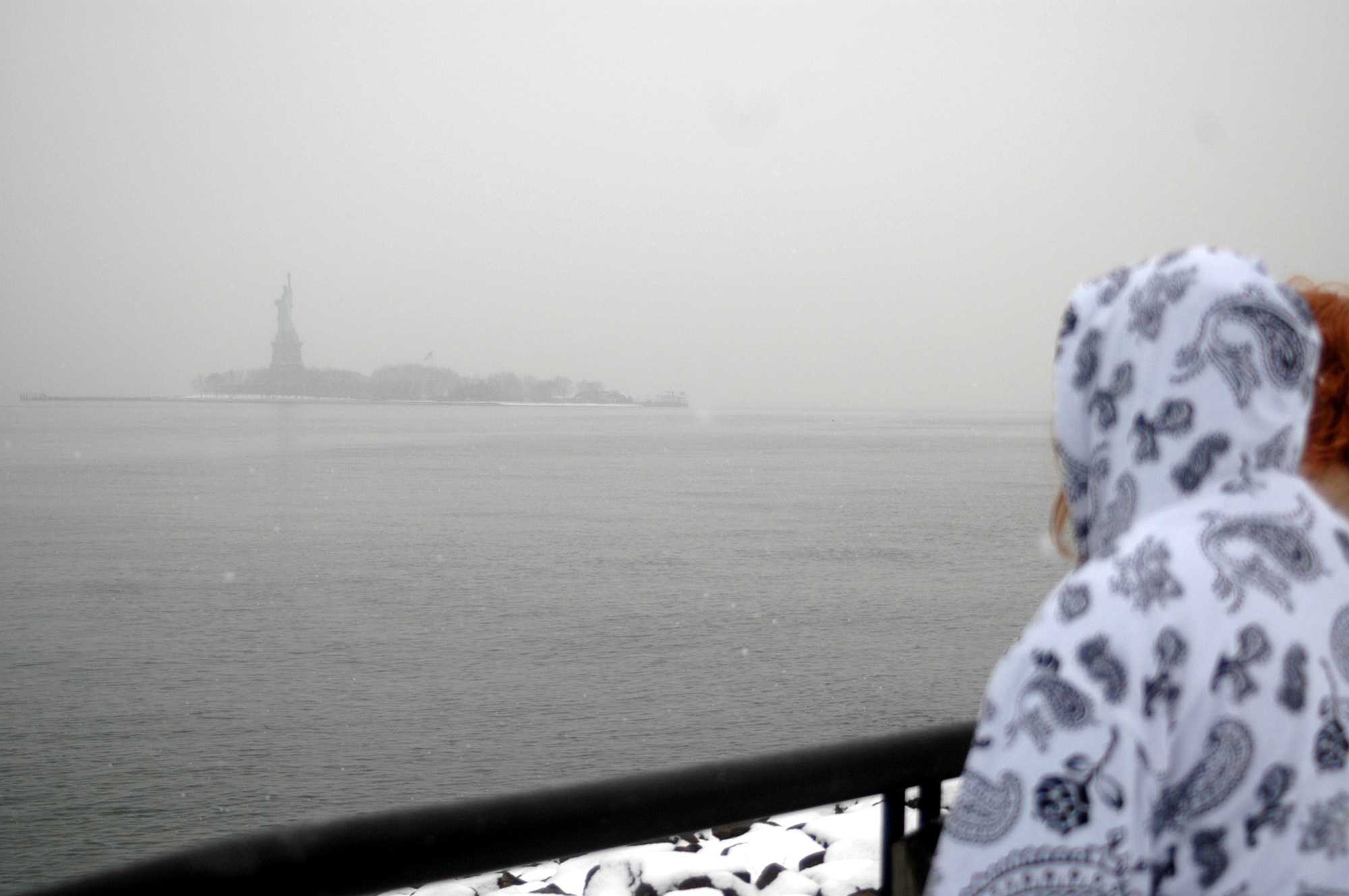 People visiting Liberty State Park, N.J., look out at the Statue of Liberty in New York Harbor Jan. 19, 2009.  (U.S. Air Force Photo/Tech. Sgt. Scott T. Sturkol)