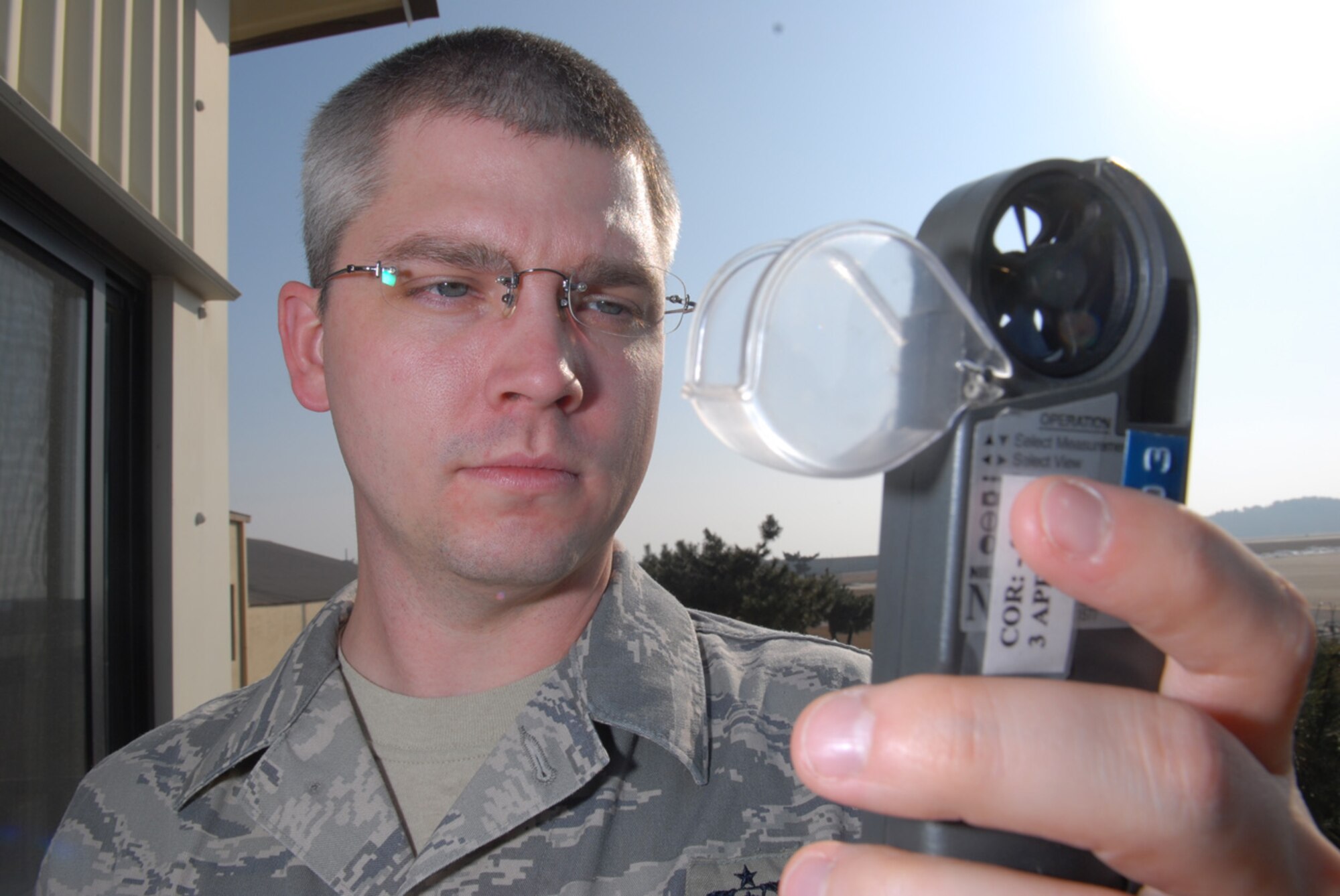 Technical Sgt. Nathan Taylor, 8th Operations Support Squadron, NCOIC of Airfield Weather Element uses a weather tracker to measure environmental conditions at Kunsan Air Base, Republic of Korea, Jan. 22, 2009.Sergeant Taylor is able to read the temperature, humidity, wind speed, wind chill, dew point and many other readings to forecast Kunsan's weather. (US Air Force Photo By Senior Airman Angela Ruiz)
 