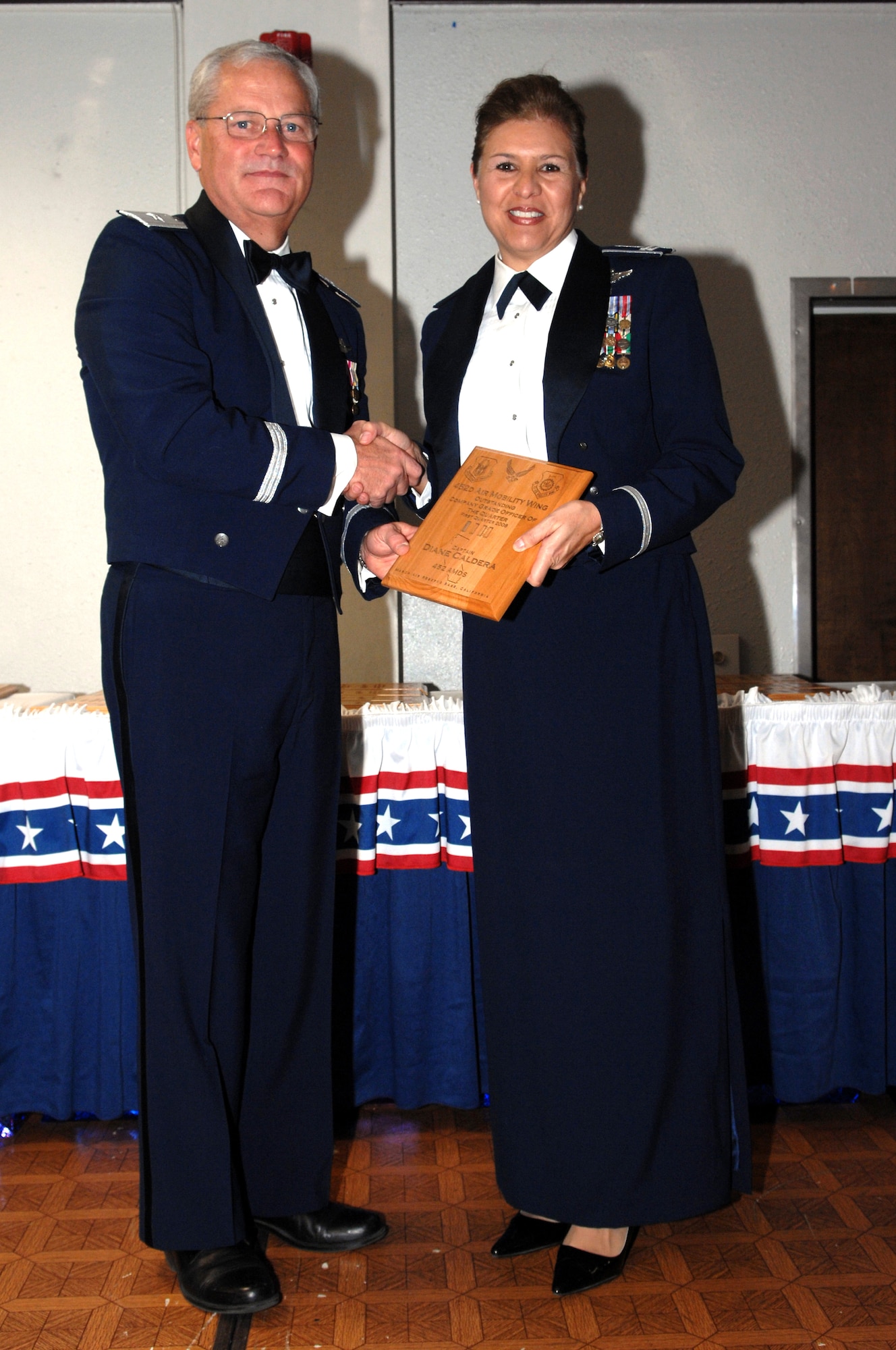 Capt. Diane M. Caldera of the 452 AMDS recieves her award for CGO of the Quarter, 1st QTR. from Brig. Gen. James L. Melin, commander, 452 AMW on Jan. 10,  2009. (Tech. Sgt. Elizabeth Concepcion)