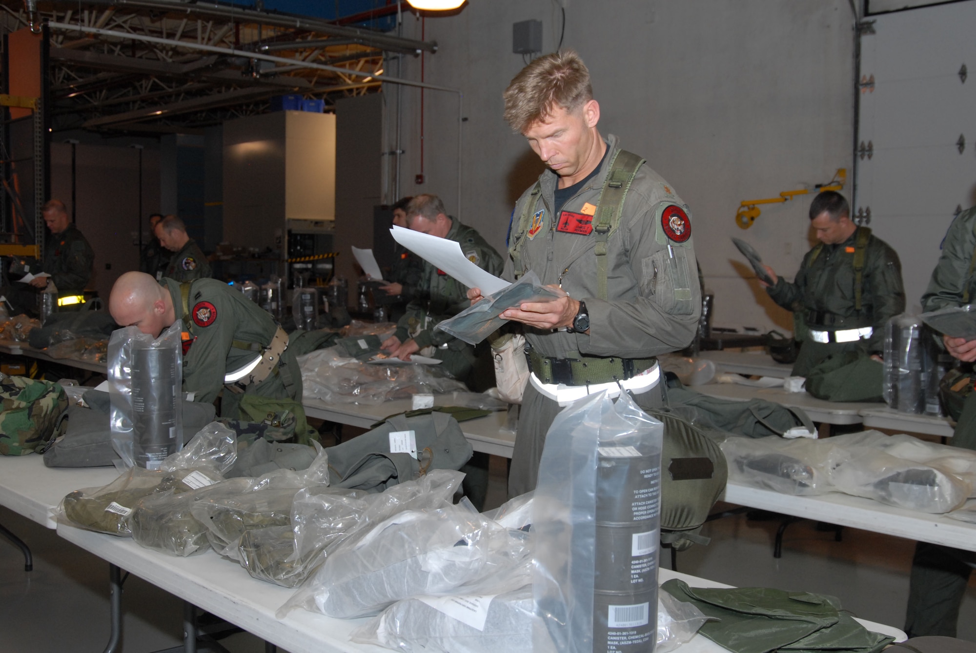 Major James T. Reeman inspects his mobility bag with others from his squadron as they practice for an upcoming ORI at the 140th Wing, Colorado Air National Guard.  