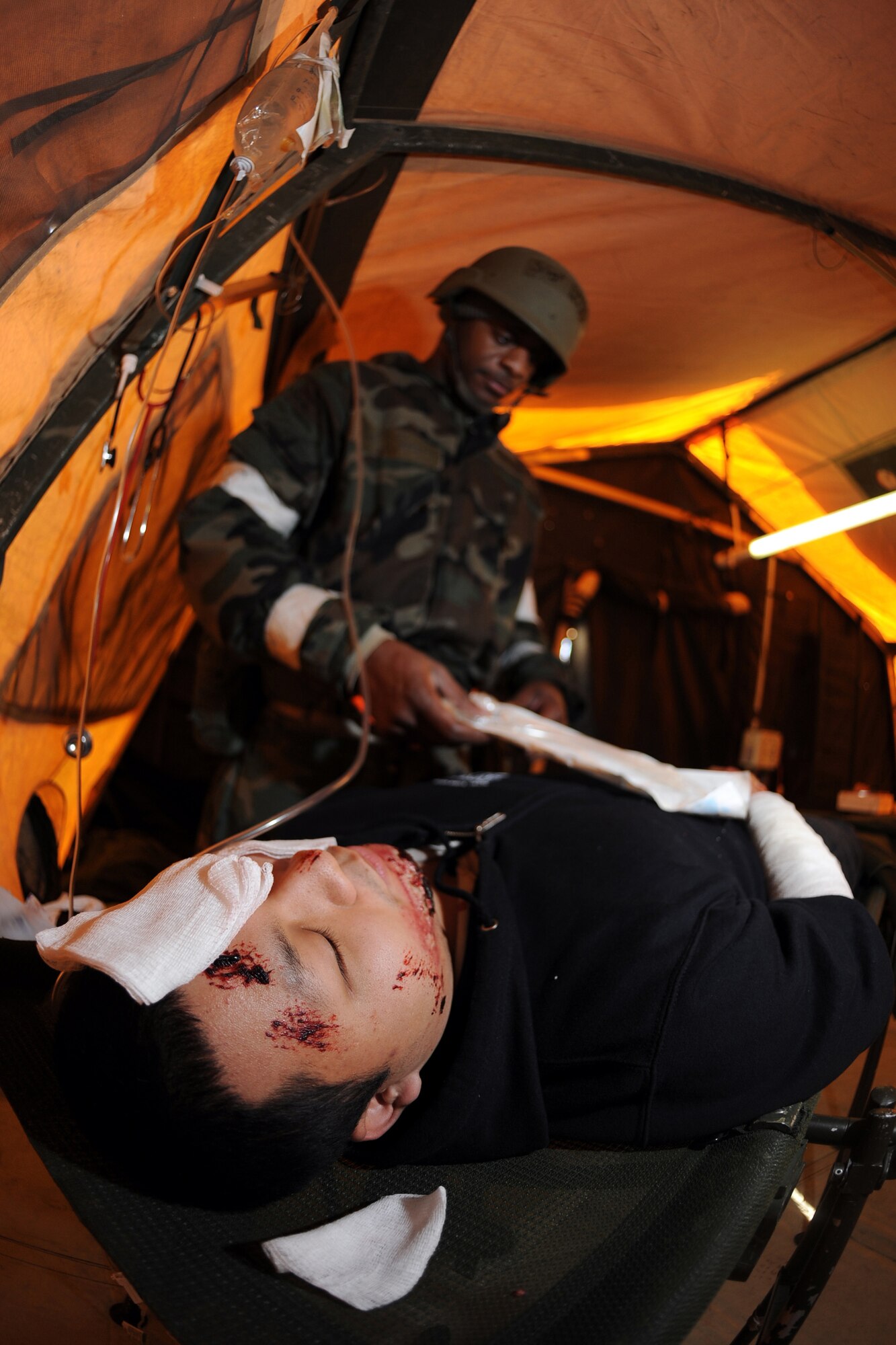OFFUTT AIR FORCE BASE, Neb. --  Senior Airman Alvar Lam, 338th Combat Training Squadron, is given breathing treatments while Staff Sgt. James Sheard, 55th Dental Squadron dental craftsman, bandages simulated wounds inside the medical tent as part of an Operational Readiness Exercise Jan. 22. The 55th Wing Airmen went through a thorough three day exercise to test their mission skills prior to deploying. The 55th Wing is in preparation for an Operational Readiness Inspection Sept. 10-16.

U.S. Air Force Photo by Josh Plueger