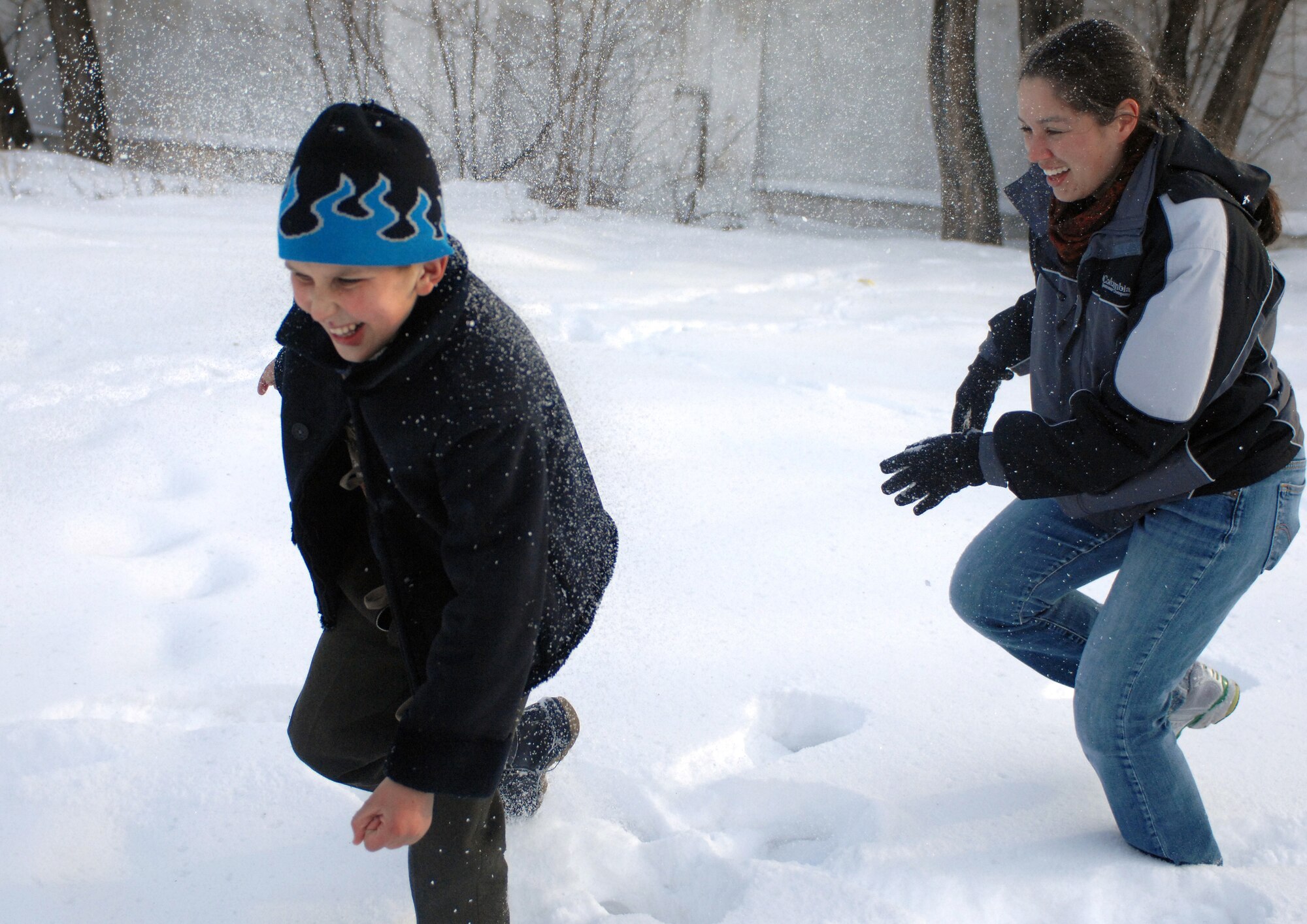 Capt. Rochelle Smith and a young boy play a friendly game of snow tag Jan. 11 at the Belovodosky orphanage north of Bishkek, Kyrgyzstan. Airmen from nearby Manas Air Base visit the orphanage frequently to share friendship and donate toys as well as clothing, blankets, diapers and toiletries. Captain Smith is deployed with the 376th Expeditionary Contracting Squadron. (U.S. Air Force photo/Tech. Sgt. Phyllis Hanson) 
