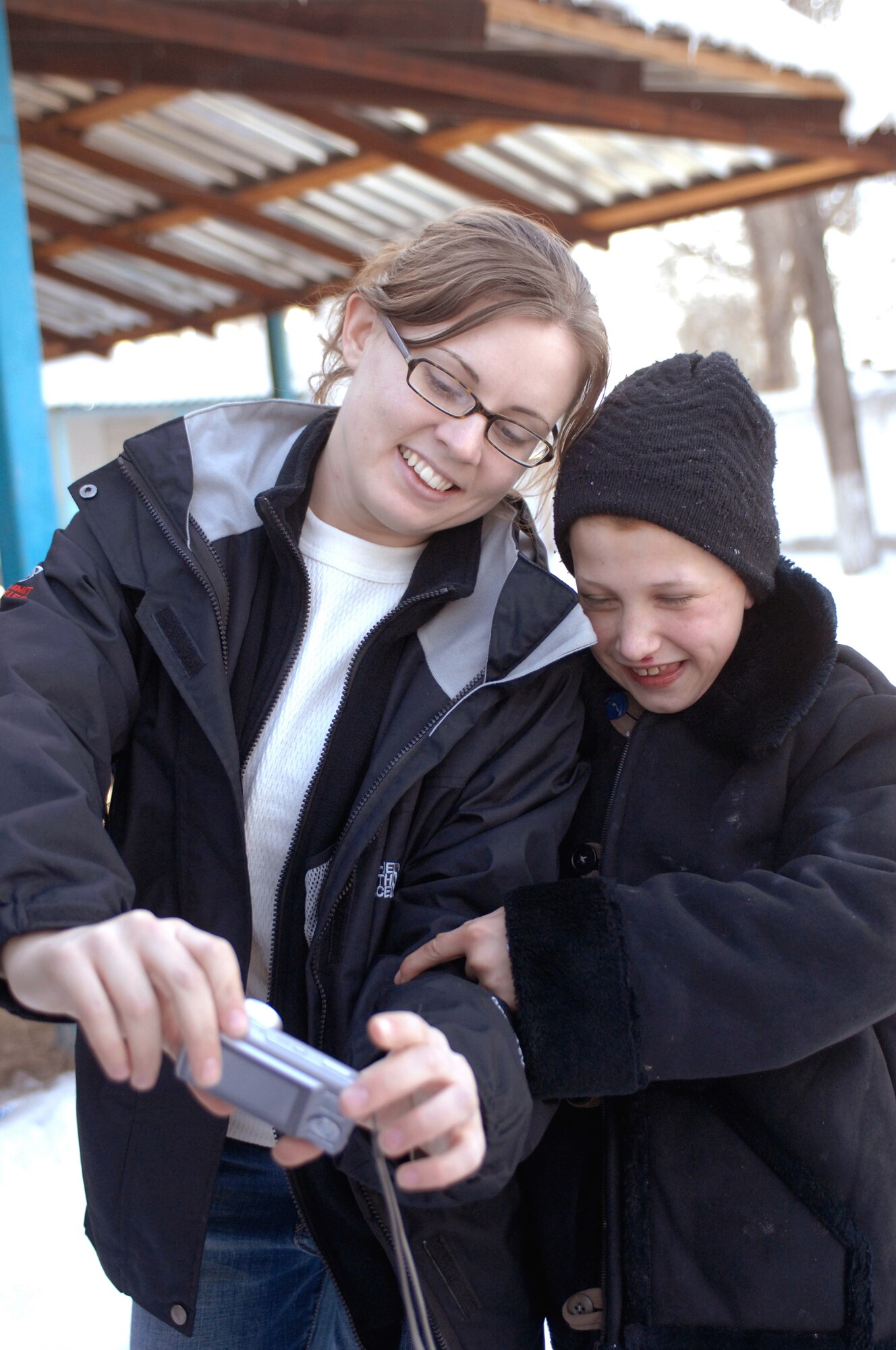 Airman 1st Class Mary Boerger shows a young boy a picture of himself taken with her camera Jan. 11 at the Belovodosky orphanage north of Bishkek, Kyrgyzstan. Airmen from nearby Manas Air Base visit the orphanage frequently to share friendship and donate toys as well as clothing, blankets, diapers and toiletries. Airman Boerger is deployed with the 376th Expeditionary Aircraft Maintenance Squadron. (U.S. Air Force photo/Tech. Sgt. Phyllis Hanson) 
