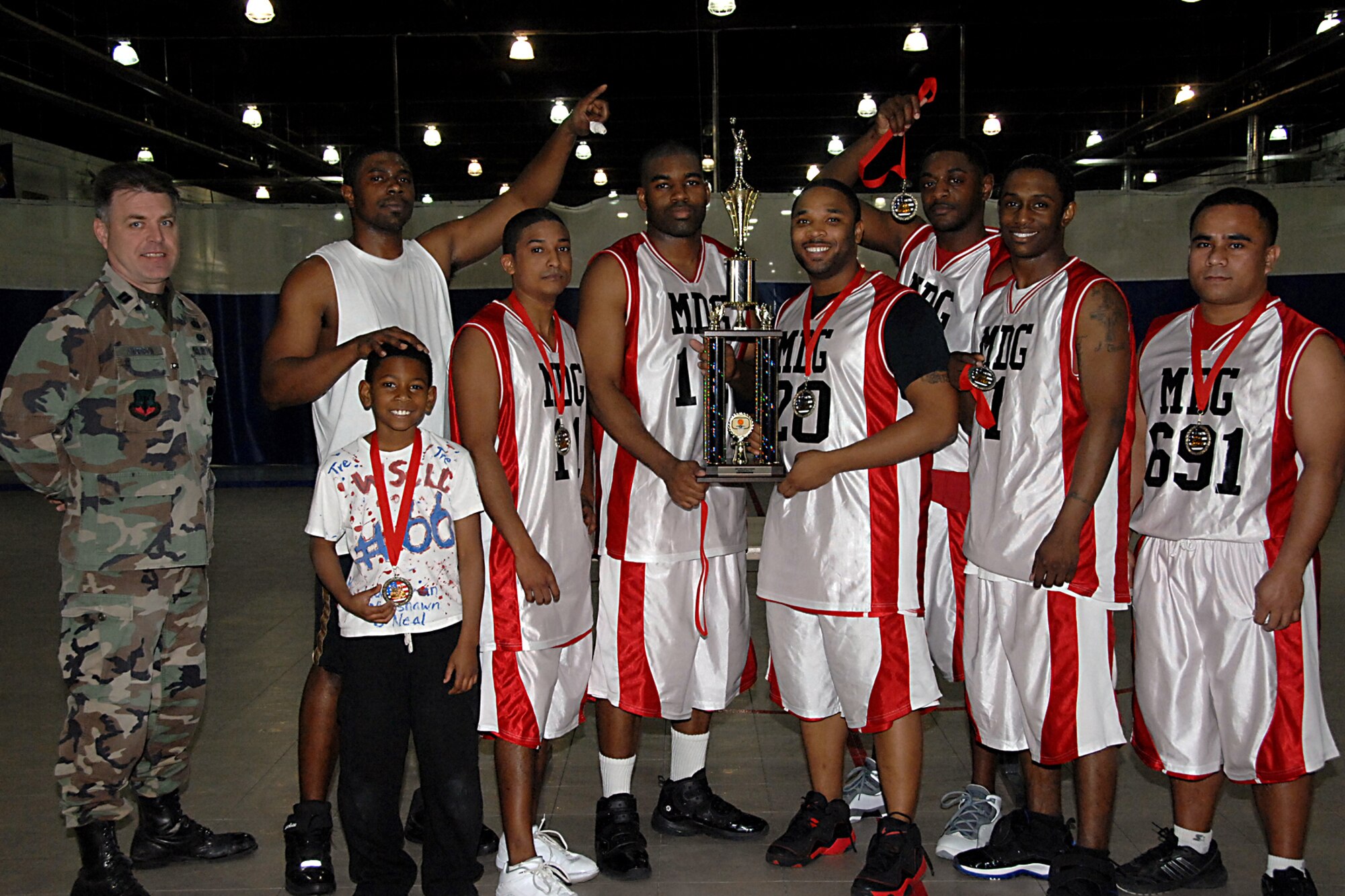 OFFUTT AIR FORCE BASE, Neb. -- Capt. James Anderson, 55th Force Support Squadron services executive poses for a group shot with the 2009 Offutt Intramural Basketball Champions at the Offutt Field House Jan. 16. The 55th Medical Group won the championship for the second year in a row against the team from U.S. Strategic Command.