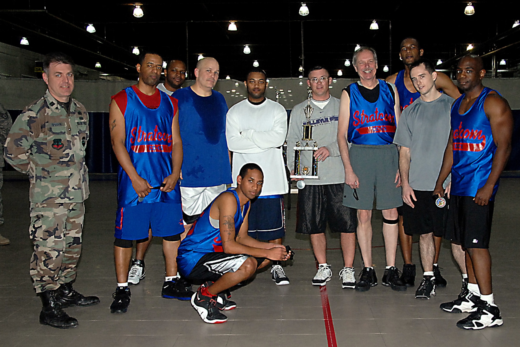OFFUTT AIR FORCE BASE, Neb. -- Capt. James Anderson, 55th Force Support Squadron Combat Support flight chief, poses with the  team from U.S. Strategic Commandin the Offutt Field House Jan. 16. The US STRATCOM team placed second in the 2009 Offutt Intramural Basketball Championship. 